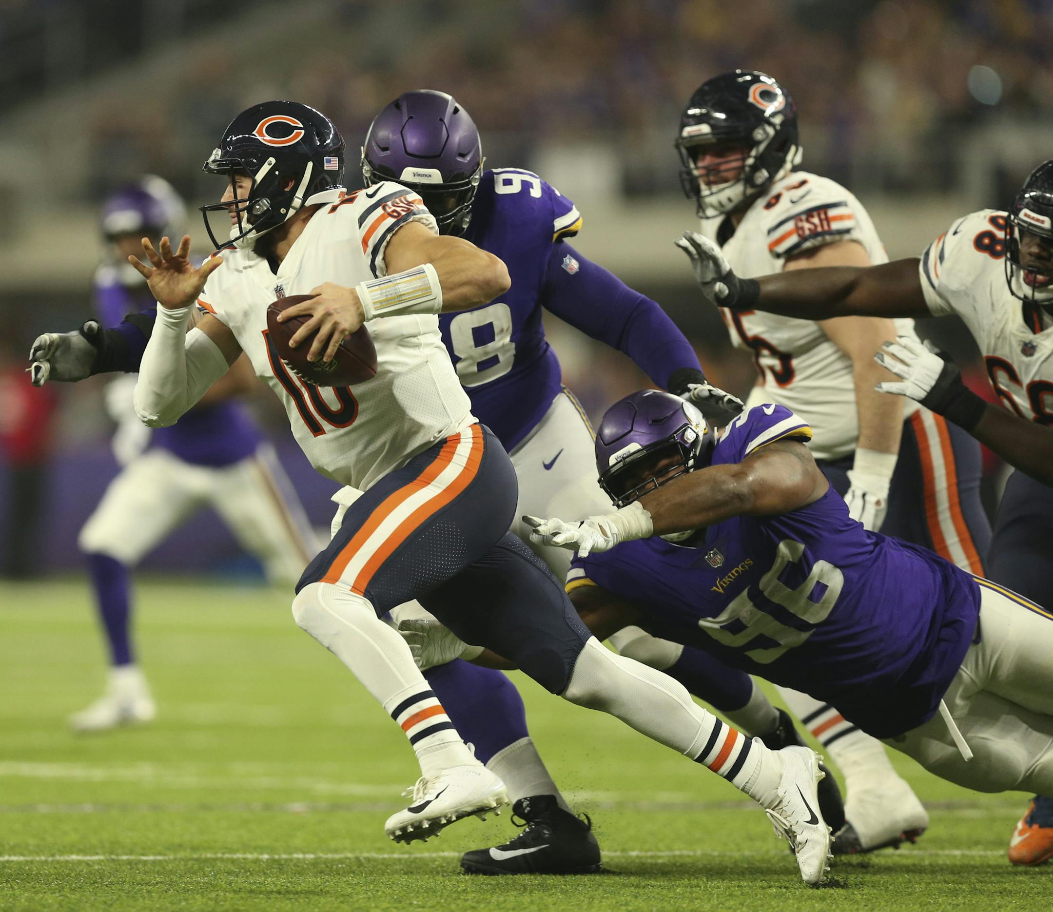 Chicago Bears quarterback Mitchell Trubisky (10) scrambled for for a five yard gain in the third quarter while pursued by Minnesota Vikings defensive tackle Linval Joseph (98) and Tom Johnson (96). ] JEFF WHEELER • jeff.wheeler@startribune.com The Minnesota Vikings ended their season with a 24-10 loss to the Chicago Bears in an NFL football game Sunday afternoon, December 30, 2018 at U.S. Bank Stadium in Minneapolis.