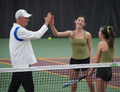Blake coach Mike Ach congratulates Rochester Mayo's Claire Loftus as her sister Aoife stands nearby.