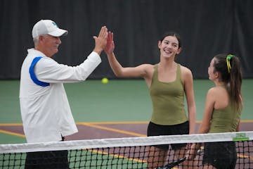 Blake coach Mike Ach congratulates Rochester Mayo's Claire Loftus as her sister Aoife stands nearby.