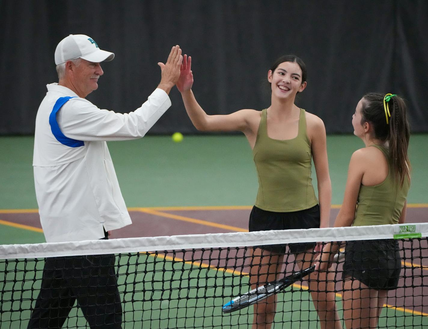 Blake coach Mike Ach congratulates Rochester Mayo's Claire Loftus as her sister Aoife stands nearby.