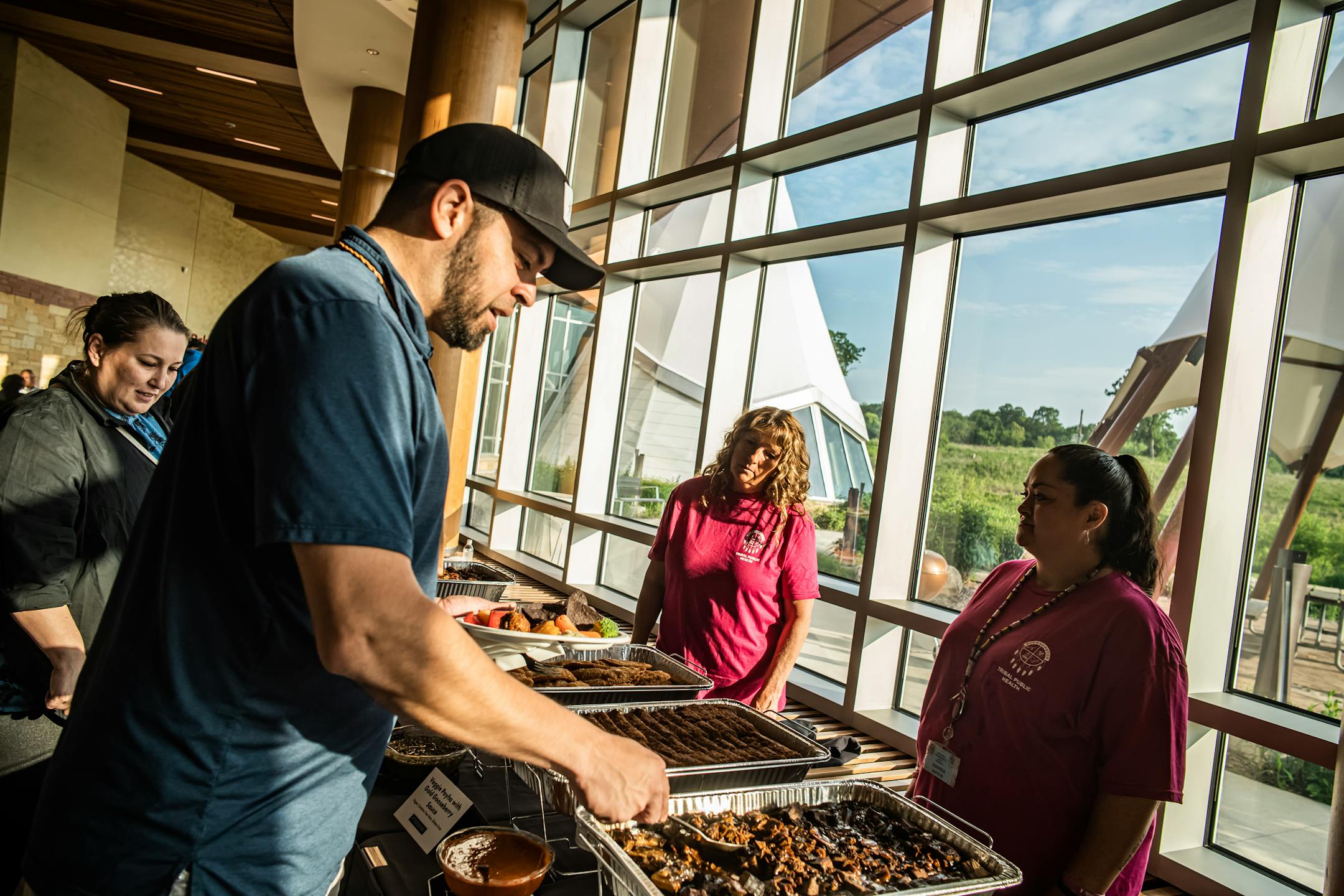 Tony Hillaire, Chairman of the Lummi Nation adds some braised buffalo short ribs to his plate in Shakopee, Minn., on Wednesday, June 7, 2023. "Working for the betterment of our people," Hillaire says is the reason he has come.