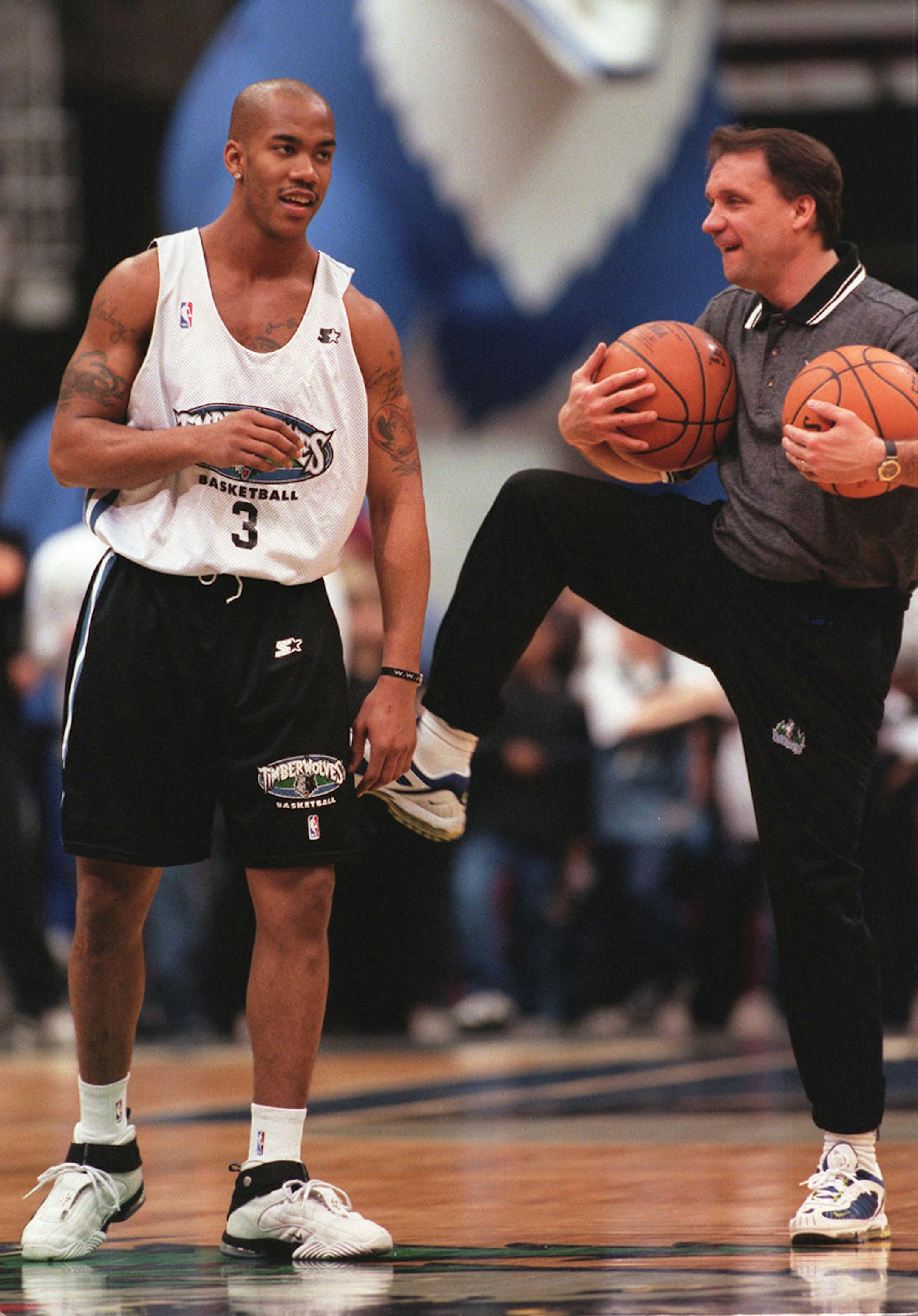 Stephon Marbury gets a swift kick from coach Phil Flip Saunders during the Timberwolves open scrimmage Monday evening at the Target center. 1/25/1999