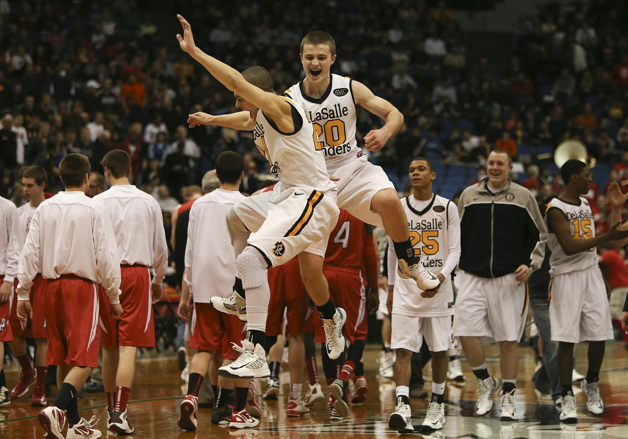 DeLaSalle's Trey Shepherd and Luke Scott celebrated after winning the class 3A boys' basketball championship at the Target Center in March. The Islanders have dominated the Tri-Metro Conference in several sports.