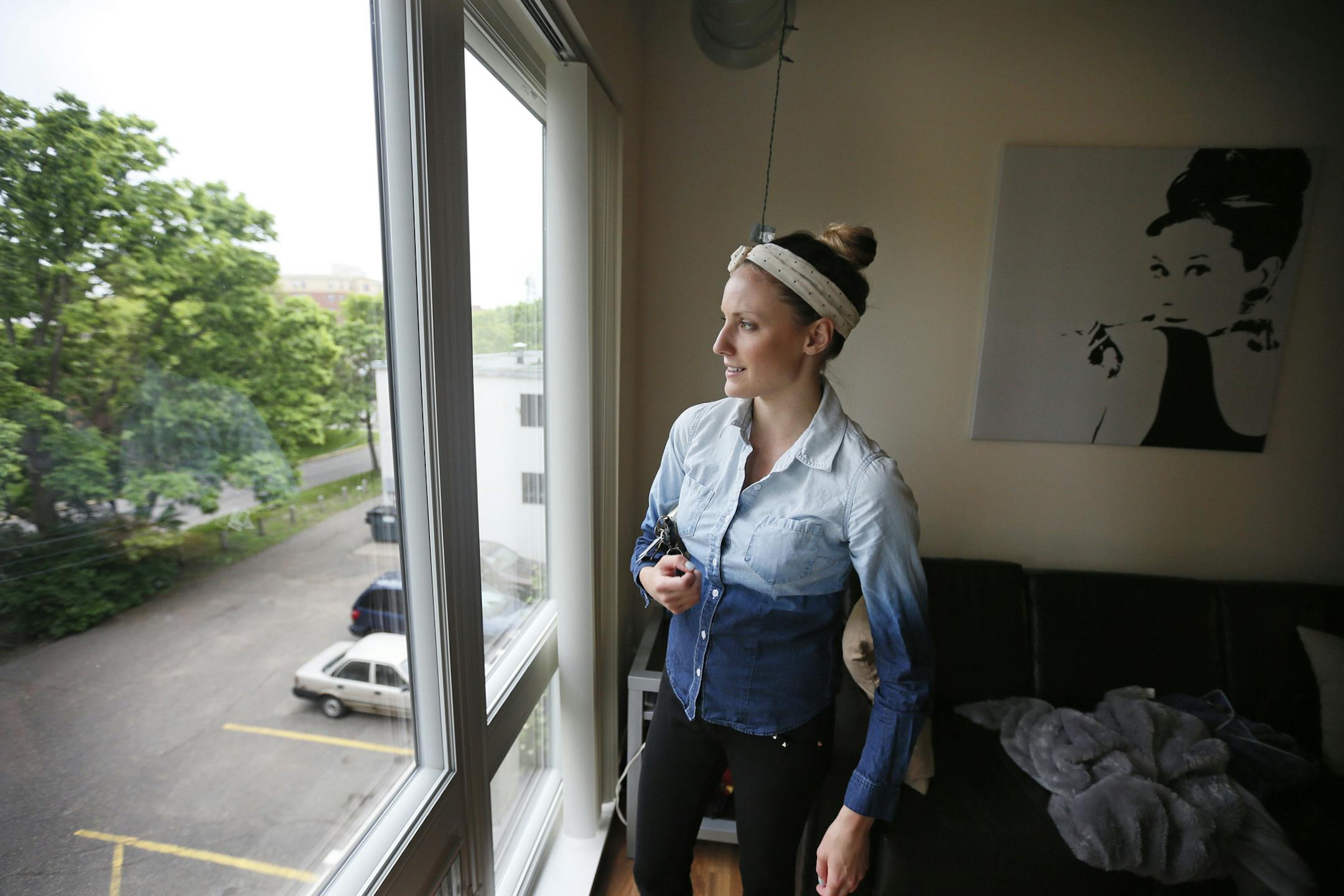 Ashley Gilles left looked out of her window at her apartment near the University of MinnesotaThursday June, 6, 2013 in Minneapolis MN. ] JERRY HOLT ‚Ä¢ jerry.holt@startribune.com