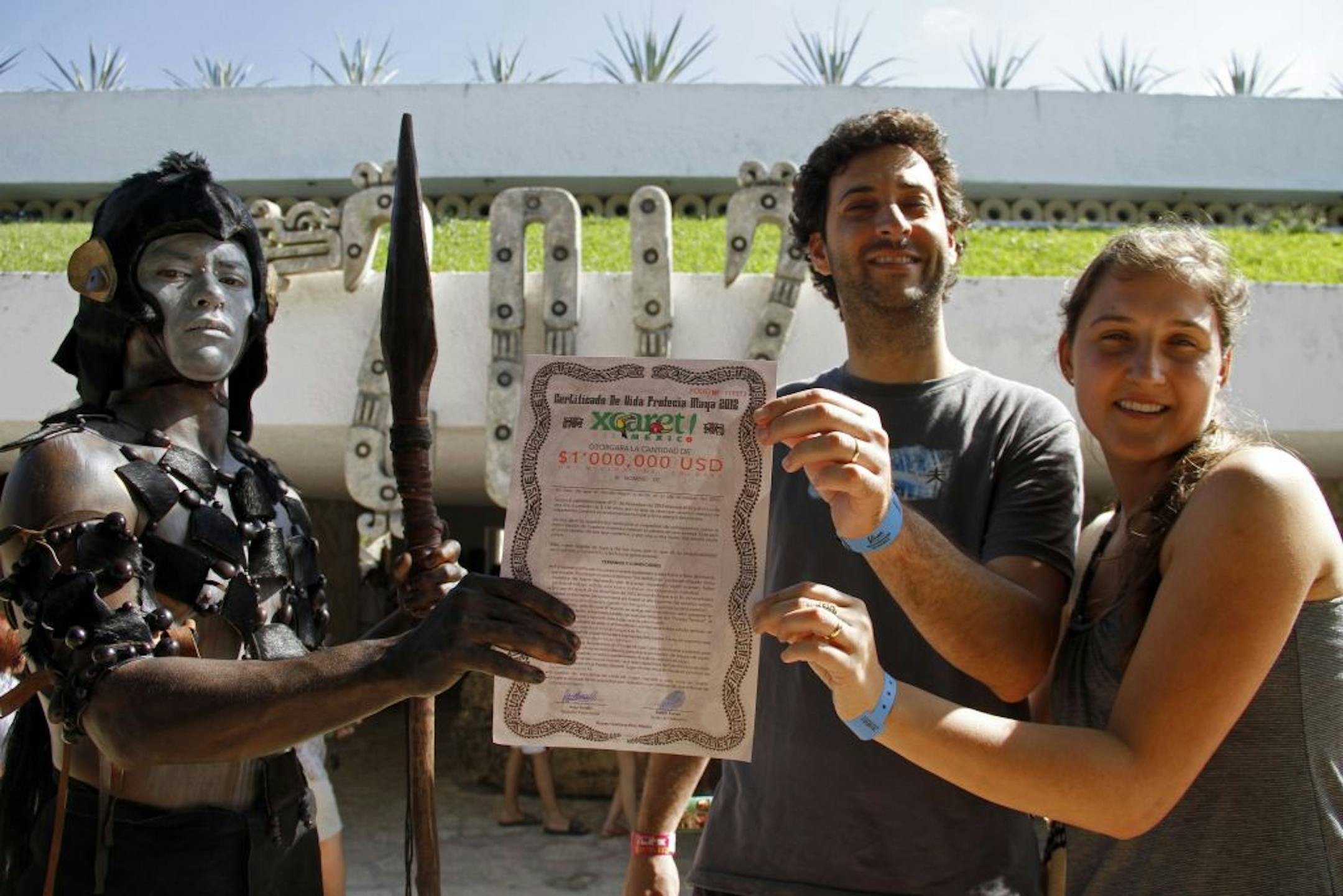 How to collect? A man dressed as a Maya warrior delivered a life-insurance certificate for $1 million, to be paid in case the world comes to an end, to an unidentified couple Saturday at the Xcaret theme park near Playa del Carmen, Mexico. Amid a worldwide frenzy of doomsdayers and New Agers preparing for a Mayan apocalypse, one group is approaching Dec. 21 with calm and equanimity: the people whose ancestors supposedly made the prediction in the first place — Mexico's estimated 800,000 Mayas.
