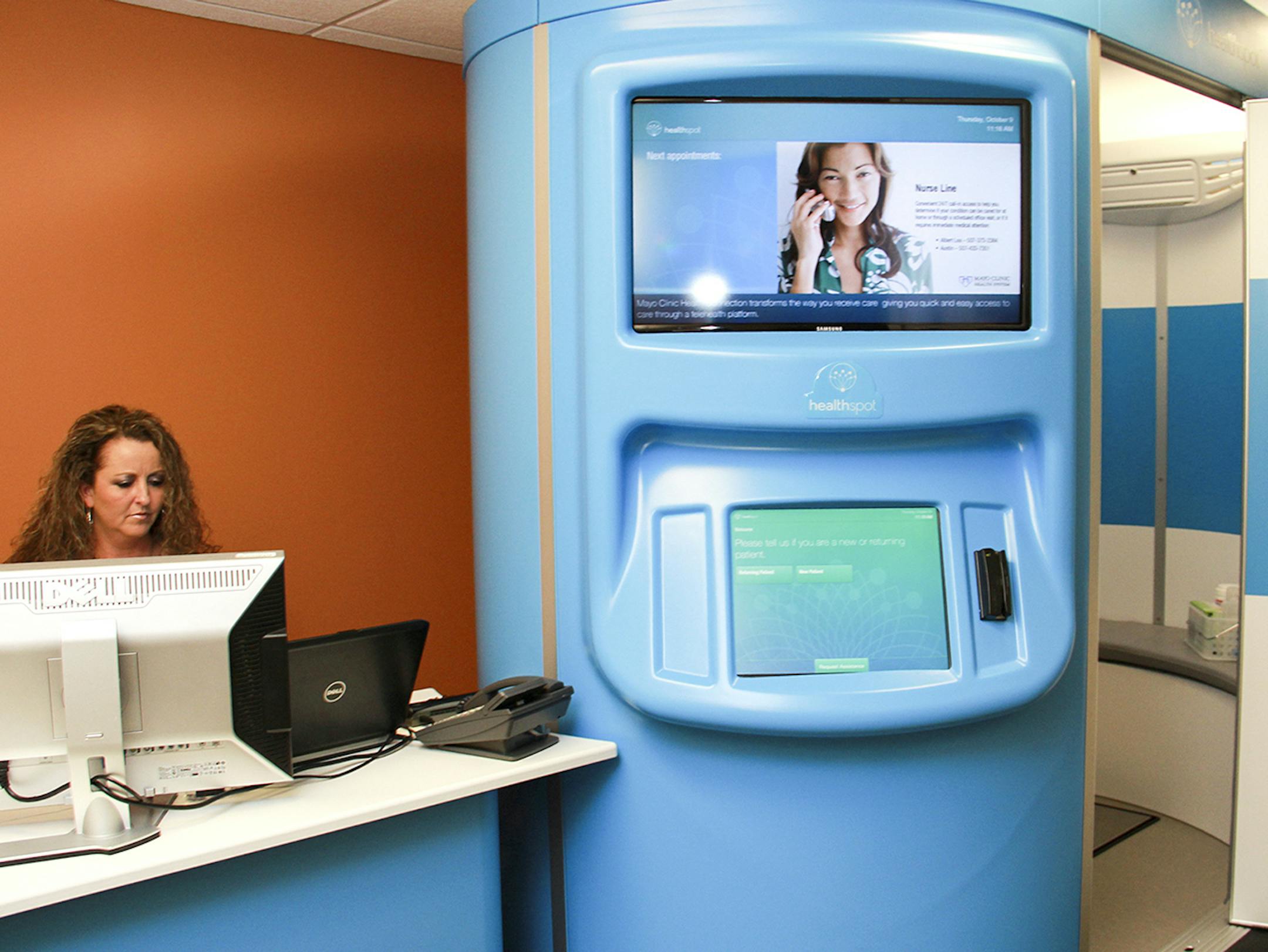 Sheryl Ellingson sits at the attendant's station of the HealthSpot kiosk at Mayo Clinic Health System in Austin Thursday. The kiosk will allow patients to be treated for acute care via teleconferencing. The Austin clinic is the pilot side for the Mayo Clinic Health Connection program and will begin by treating Mayo employees and dependents only later this month. Jason Schoonover/jason.schoonover@austindailyherald.com