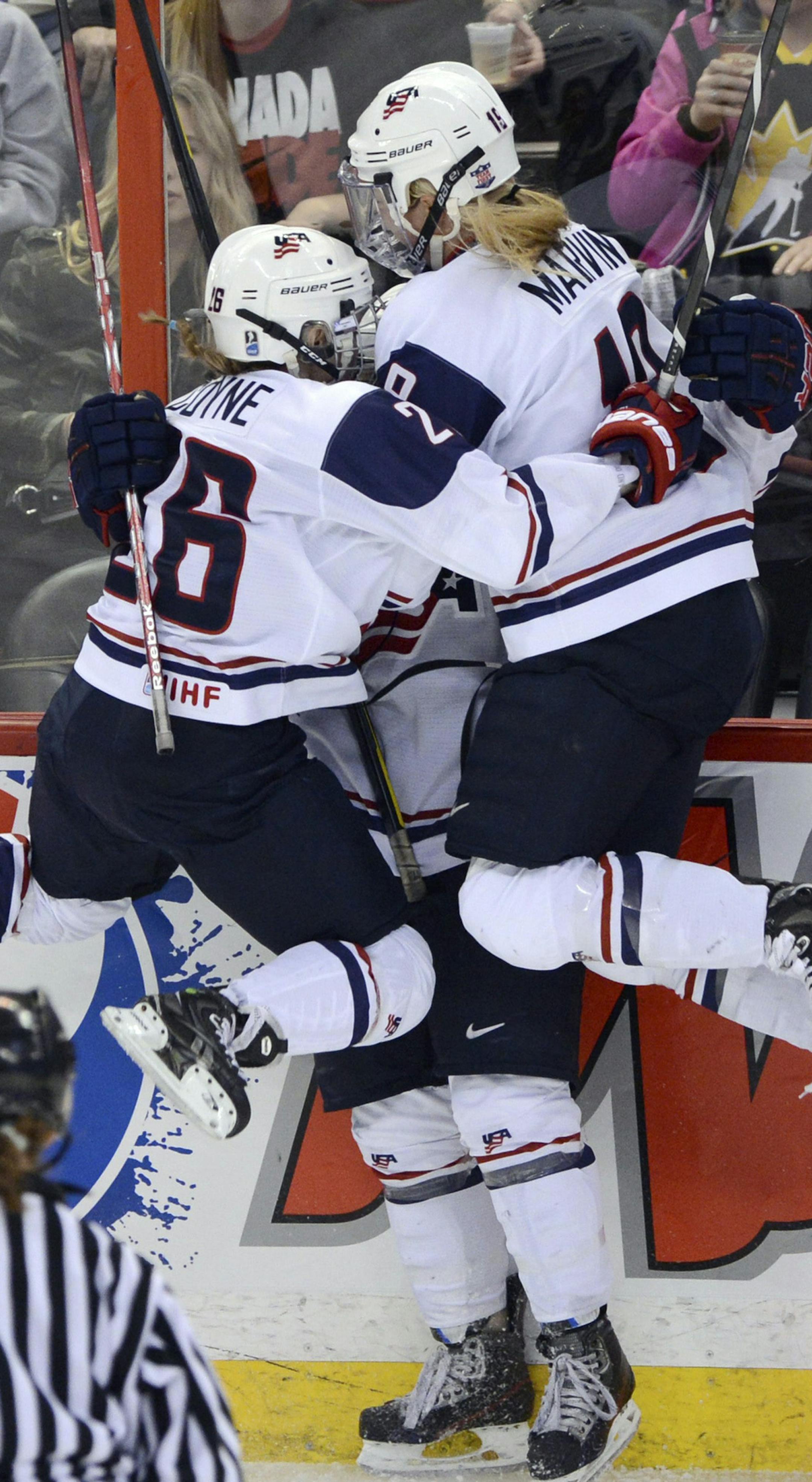 United States' Gigi Marvin, right, and Kendall Coyne jump into the arms of Brianna Decker following her goal against Canada during the second period of the gold-medal game at the women's world hockey championships in Ottawa, Ontario, Tuesday, April 9, 2013. (AP Photo/The Canadian Press, Sean Kilpatrick ORG XMIT: AJW128