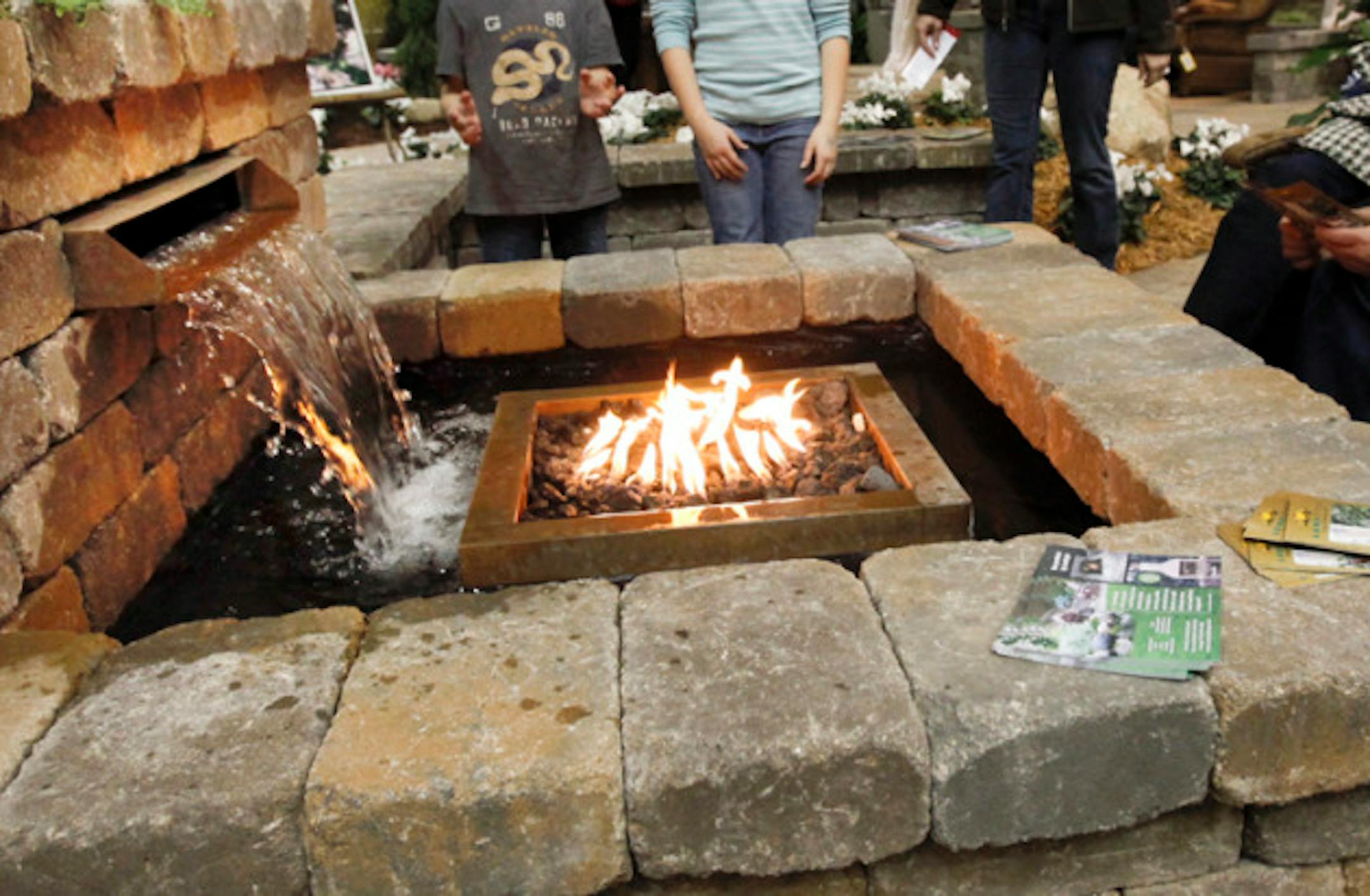 DAVID JOLES  '\u20AC' djoles@startribune.com -March 4, 2011- Minneapolis, MN-  More than 1,000 experts and vendors have set up shop at the Minneapolis Convention Center for the Home and Garden Show.  In this photo:] Gavin Drews, 6, and his sister Mackenzie, 9, of Montrose, watched as fire and water mixed in a outdoor patio display by Landscape Design and Style Ltd. Brother and sister took in the show with their mom Amada Drews of Montrose.