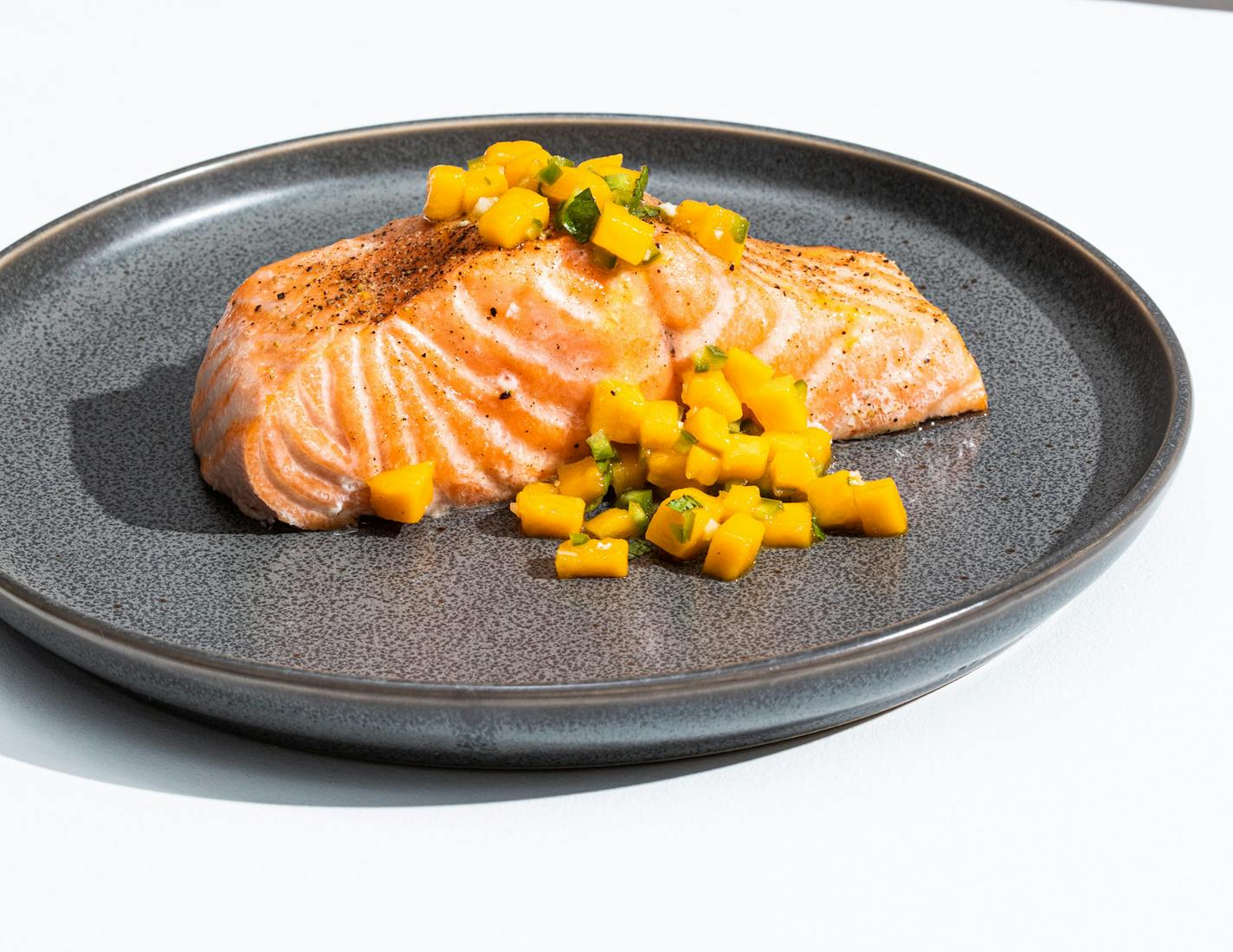 Oven-Roasted Salmon with Mango-Mint Salsa from "The Complete Cookbook for Teen Chefs," by America's Test Kitchen. Credit: America's Test Kitchen