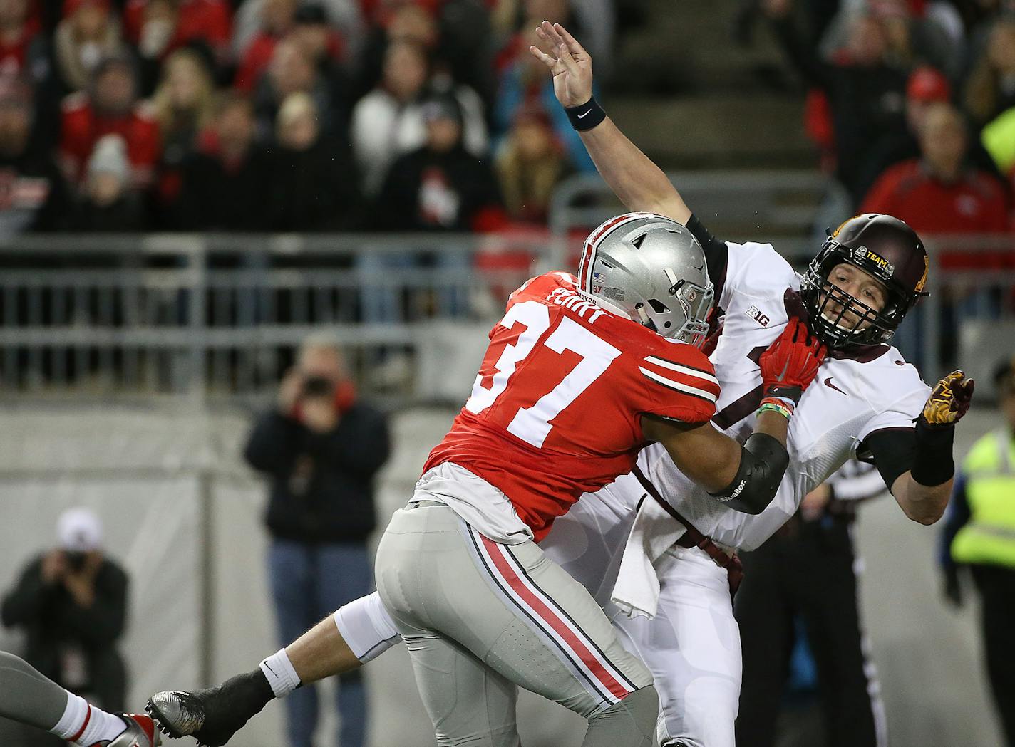 Ohio State's linebacker Joshua Perry tackled Minnesota's quarterback Mitch Leidner just as he threw an interception for an Ohio touchdown in the second quarter the Minnesota Gophers took on the Ohio State Buckeyes at Ohio Stadium, Saturday, November 7, 2015 in Columbus, OH. ] (ELIZABETH FLORES/STAR TRIBUNE) ELIZABETH FLORES � eflores@startribune.com