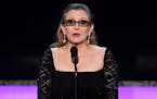 FILE - In this Sunday, Jan. 25, 2015 file photo, Carrie Fisher presents the life achievement award on stage at the 21st annual Screen Actors Guild Awa