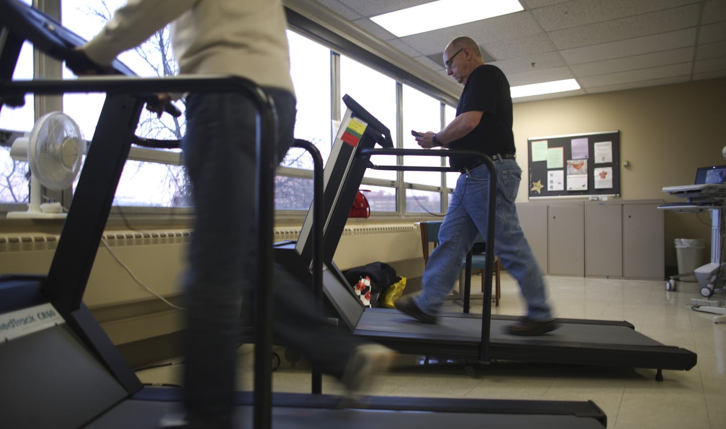 Mike McKee walked on a treadmill in the cardiac rehabilitation clinic at the University of Minnesota Medical Center, Fairview Monday evening. ] JEFF WHEELER &#x201a;&#xc4;&#xa2; jeff.wheeler@startribune.com Mike McKee was walking about 8 miles a day when he collapsed from a heart attack in 2008. A defibrillator and a stent got him back on the road until last year, when clogged arteries in his legs caused severe pain. Now, he's enrolled in a special exercise program designed at the University of