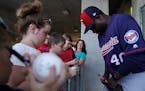 Twins first base coach Tommy Watkins signed autographs in Fort Myers during spring training workouts.