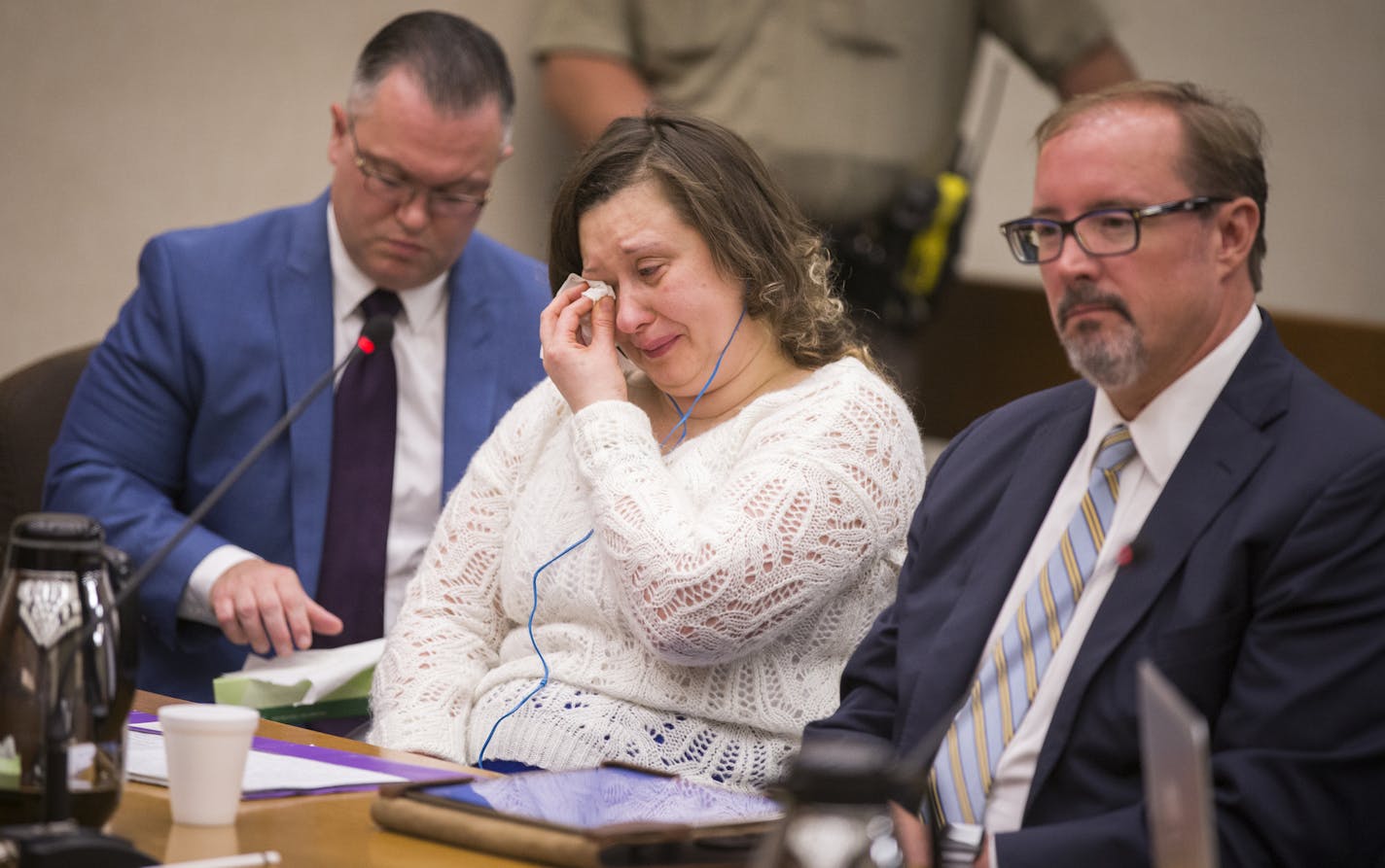 Nataliia Karia, center, with her lawyers Brock Hunter, right, and Ryan Else, reacts during her sentencing hearing. ] LEILA NAVIDI &#xef; leila.navidi@startribune.com BACKGROUND INFORMATION: Nataliia Karia is sentenced to probation by Judge Jay M. Quam in Hennepin County District Court on Monday, July 16, 2018. Karia is the babysitter who pleaded guilty in February to wrapping a pair of tights around a 16-month old's neck and hanging him from piping in the basement of her south Minneapolis house.