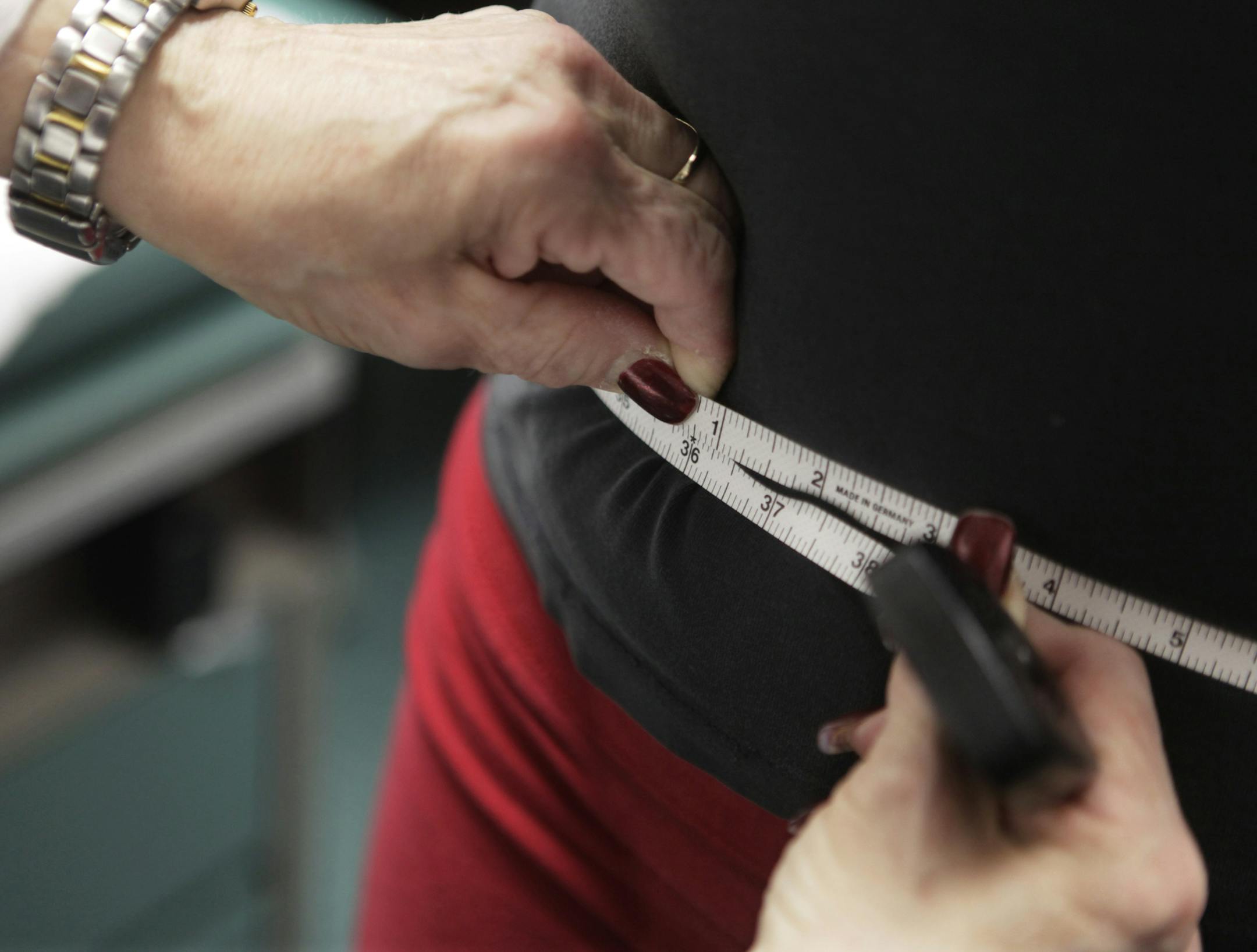 FILE - In this Jan. 20, 2010, file photo, a waist is measured during an obesity prevention study at Rush University Medical Center in Chicago. The bathroom scale may show a good number but how much of that weight is fat, not muscle? New studies are adding to the evidence that the scale doesn't always tell the whole story when it comes to weight-related health risks. (AP Photo/M. Spencer Green, File)
