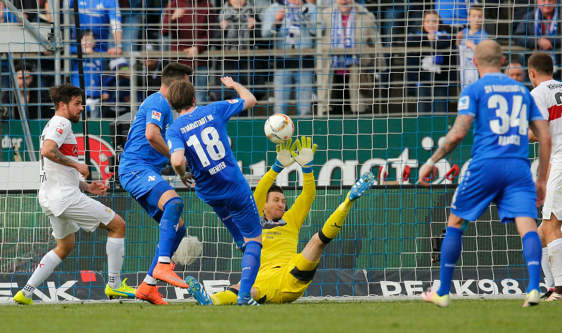 stuttgart's goalie Przemyslaw Tyton saves a shot by Darmstadt's Peter Niemeyer , third from left, during teh German Bundesliga soccer match between Darmstadt 98 and VfB Stuttgart in Darmstadt, Germany, Saturday April 2, 2016. ( Ronald Wittek/dpa via AP)