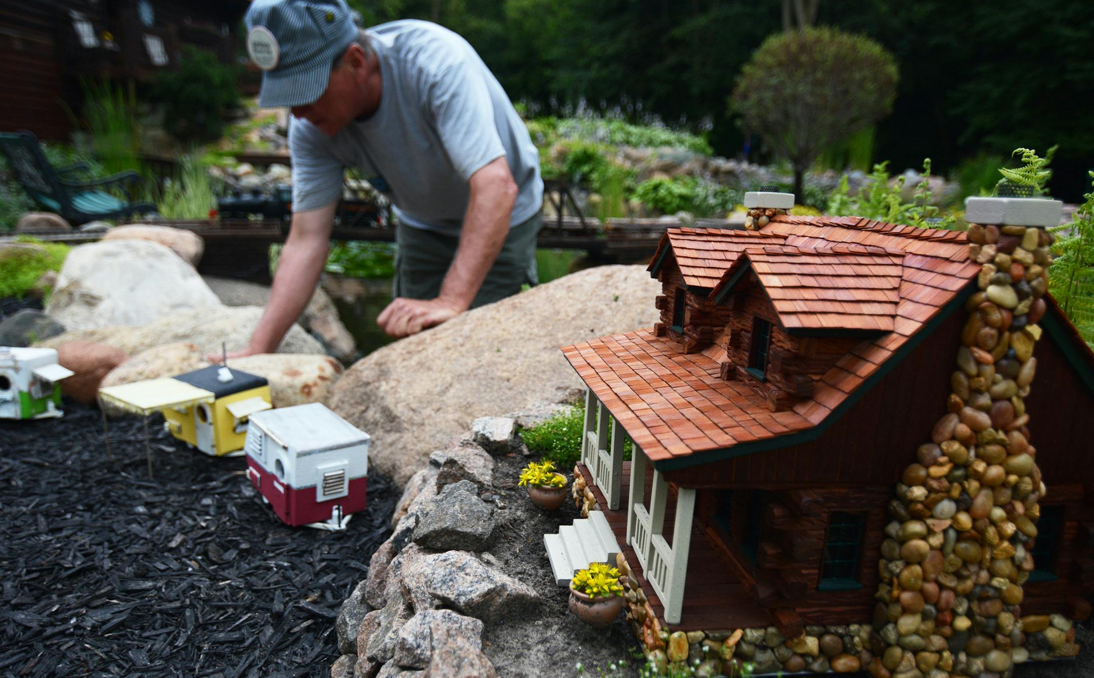 Jim Shaver stood next to his garden railway in Mound. Shaver built this house on the railway to replicate his own log home he built and designed himself. Photo by Liz Rolfsmeier, Special to the Star Tribune