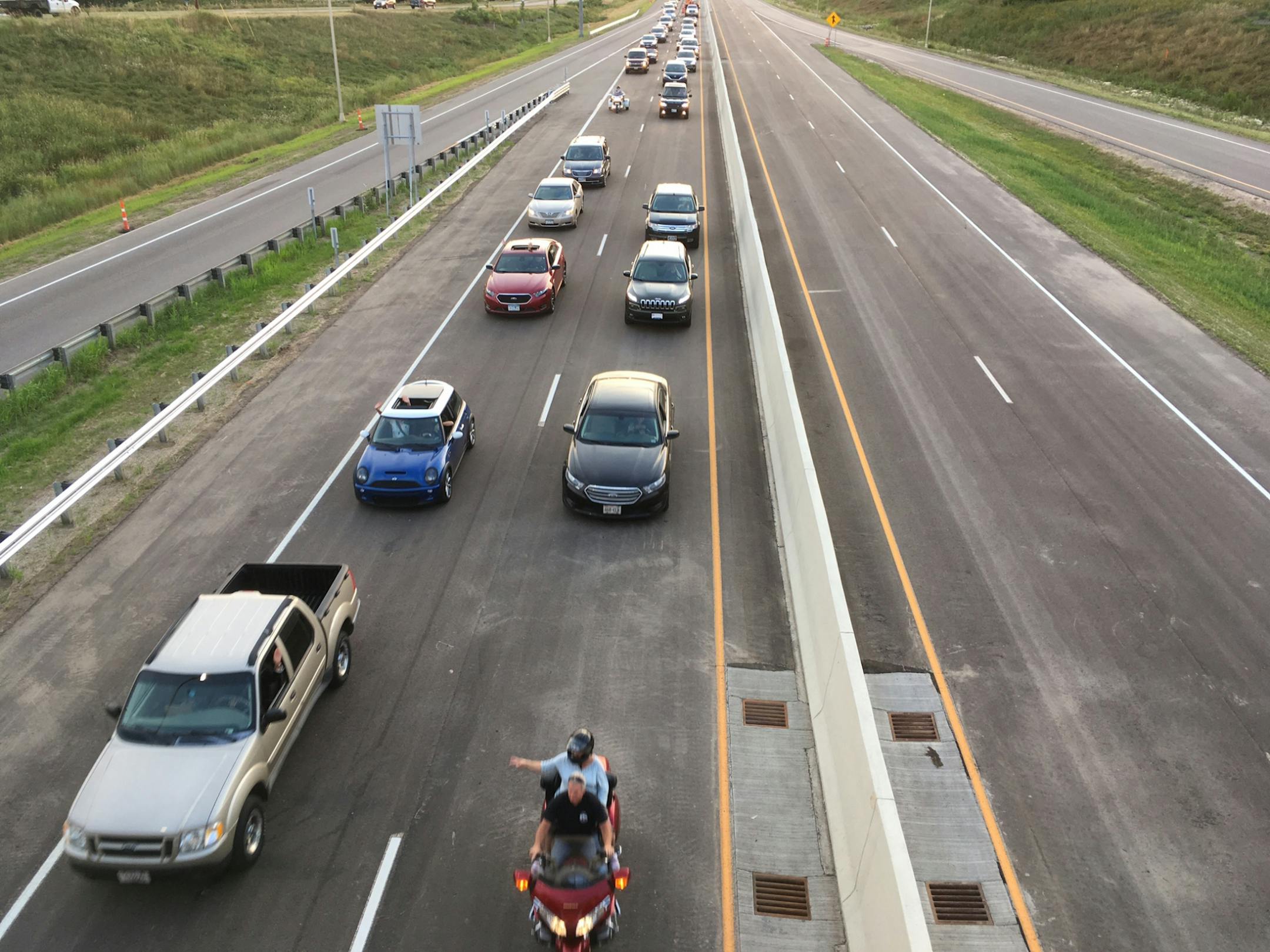 The first cars to cross the St. Croix River bridge leave Oak Park Heights on Wednesday on their way to the milelong span. 8/2/17