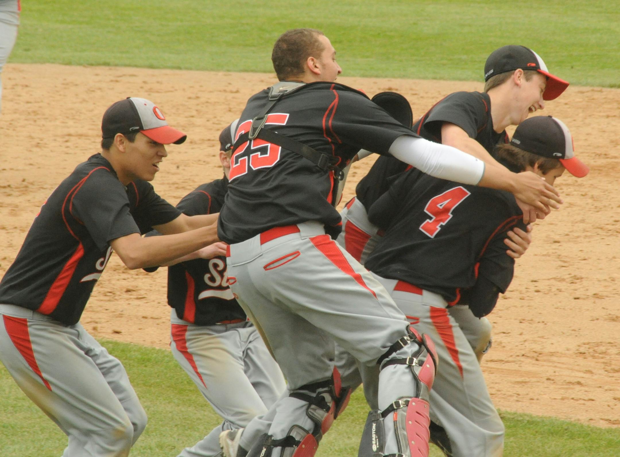 Teammates tackled Osakis first baseman Grayson Fortenberry (4) after he caught the final out of the Section 5A title game in what was a 4-6-3 double play to wrap up this program&#xed;s first section title against Hinckley-Finlayson on June 7 in St. Cloud.