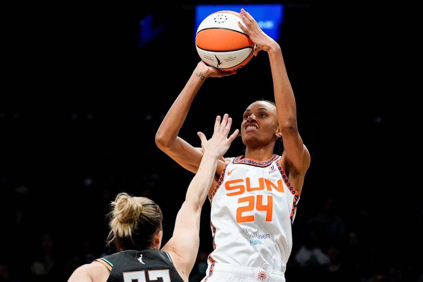 Connecticut Sun forward DeWanna Bonner (24) shoots over New York Liberty guard Sami Whitcomb (32) in the first half during a WNBA basketball game, Tuesday, May 17, 2022, in New York. (AP Photo/John Minchillo)