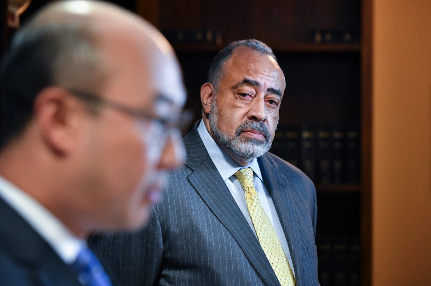 Don Lewis, background, looks on Friday as Ramsey County Attorney John Choi announces that he's adding Lewis to help as a special prosecutor in the inquiry into the death of Philando Castile.