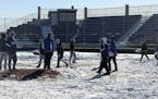 Woodbury baseball teams shoveling off its field