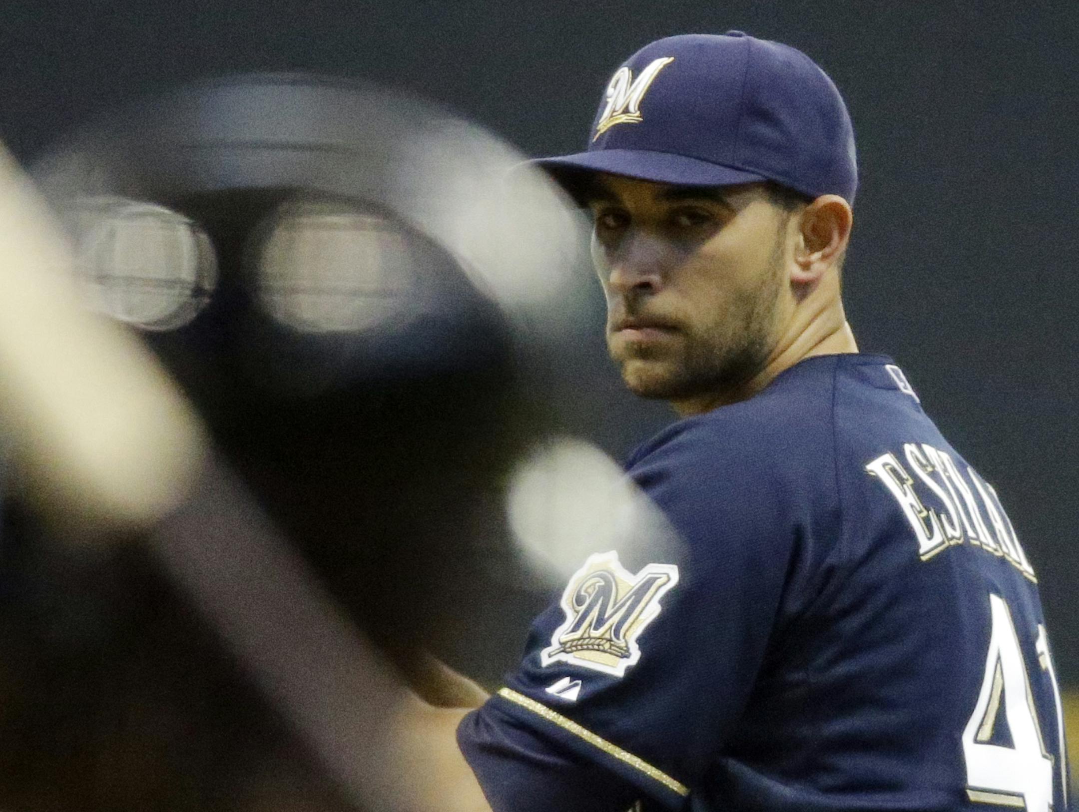 Milwaukee Brewers starting pitcher Marco Estrada, right, throws to Pittsburgh Pirates' Andrew McCutchen during the first inning of a baseball game on Friday, May 24, 2013, in Milwaukee. (AP Photo/Morry Gash) ORG XMIT: MIN2013052823565130