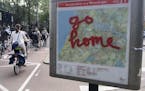In this May 11, 2016 photo, graffiti reading "Go Home" is sprayed on a map of bicycle paths at the entrance to Amsterdam's Vondelpark, a popular spot 