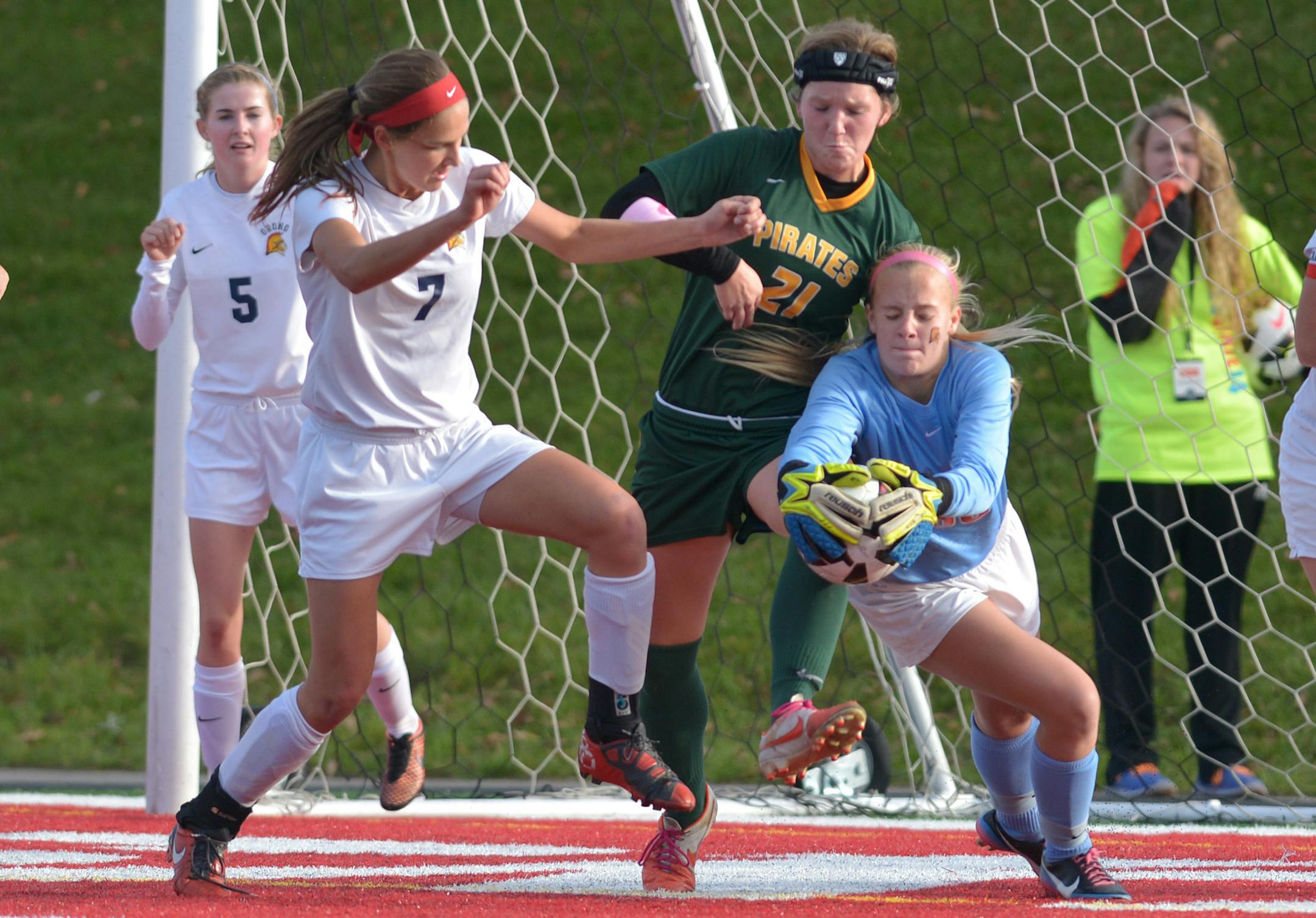Orono's goalkeeper Jessica Woessner grabs a loose ball past Orono's Danielle Jorgensen and Park Center's Mollie Monson during the second half of the Class 1A Girls' semifinal game Wednesday, October 29 at Husky Stadium in St. Cloud. Orono's 4-0 victory over Park Center sends the Spartans to the championship Thursday, October 30. ] (SPECIAL TO THE STAR TRIBUNE/BRE McGEE) **Jessica Woessner (goalkeeper, blue), Danielle Jorgensen (7, white), Mollie Monson (green, 21)