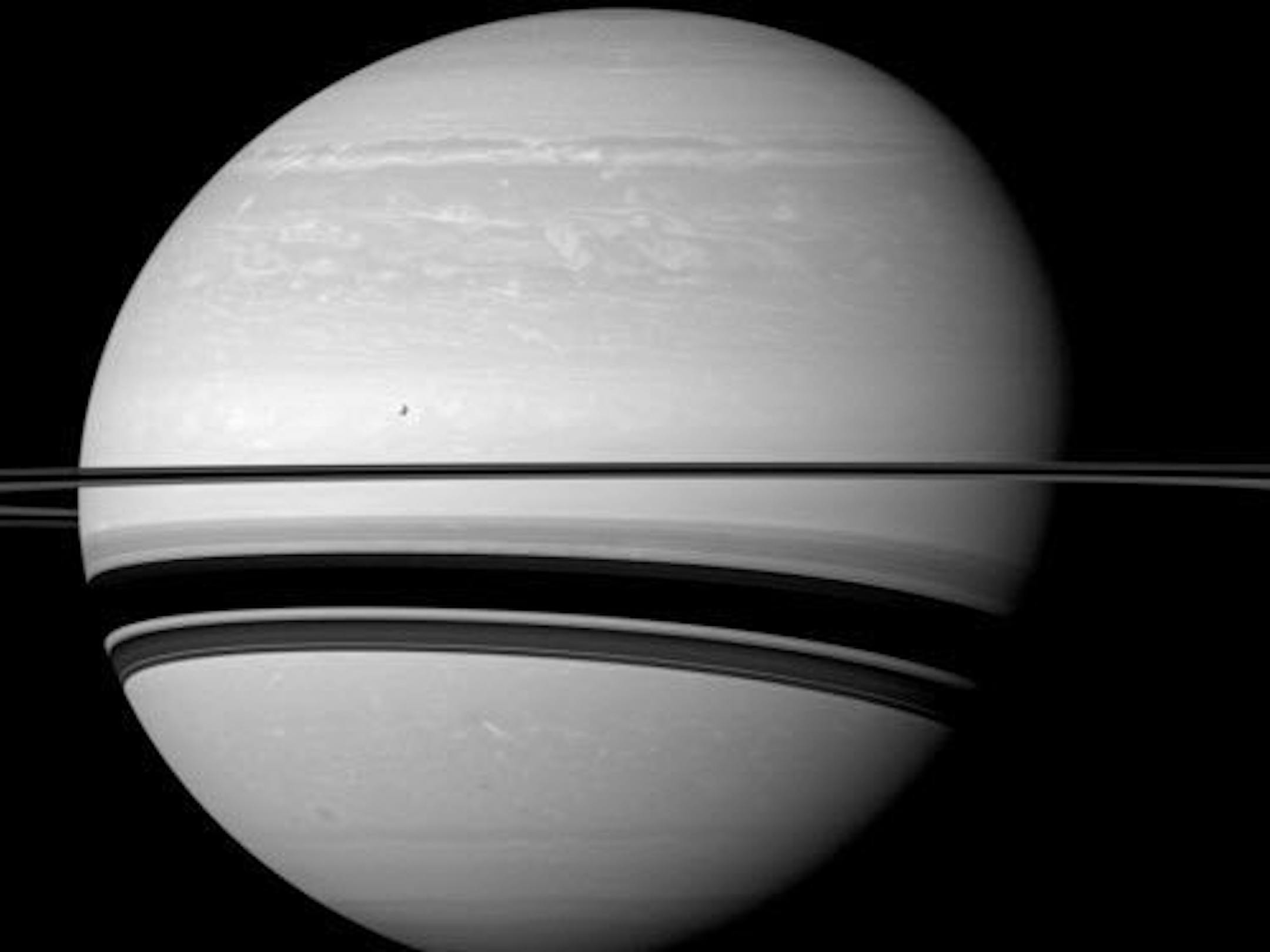 This Jan. 10, 2012 image made available by NASA shows Saturn and one of its moons, Tethys, as seen from the Cassini spacecraft.