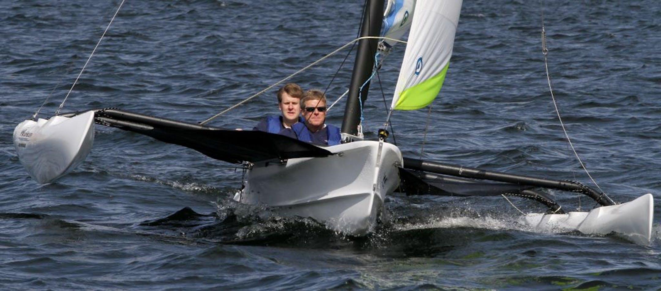 (left to right) Robert Sanberg and Dean Sanberg, of WindRider International, tested one of their 17-foot trimaran sailboats on Lake Calhoun. The father-son team aquired the almost dormant company, that was facing closing, and moved production from Pine City to Minneapolis.
