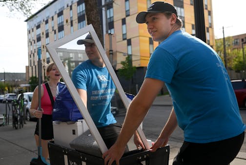 Conner Hartwig helps his sister, Cassie, move into her new apartment Wednesday, May 10, 2023, in Dinkytown, Minn.