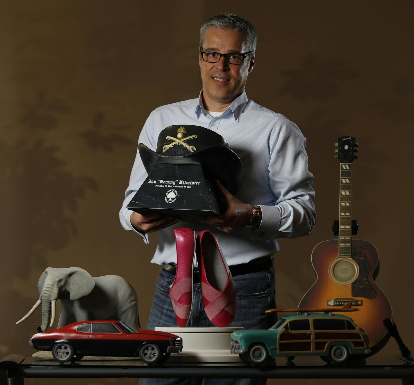 Pete Saari, owner of the Eden Prairie company Foreverence, shows a selection of urns that were created by 3-D printing.