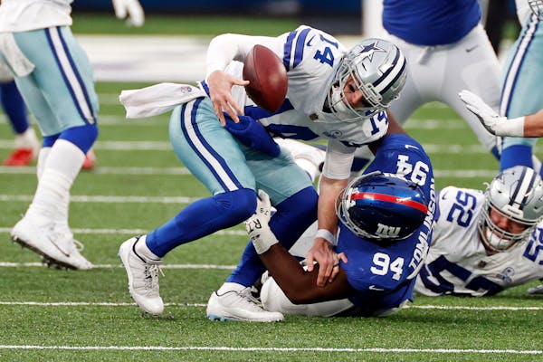 Giants nose tackle Dalvin Tomlinson sacked  Cowboys quarterback Andy Dalton during a Week 17 game. 