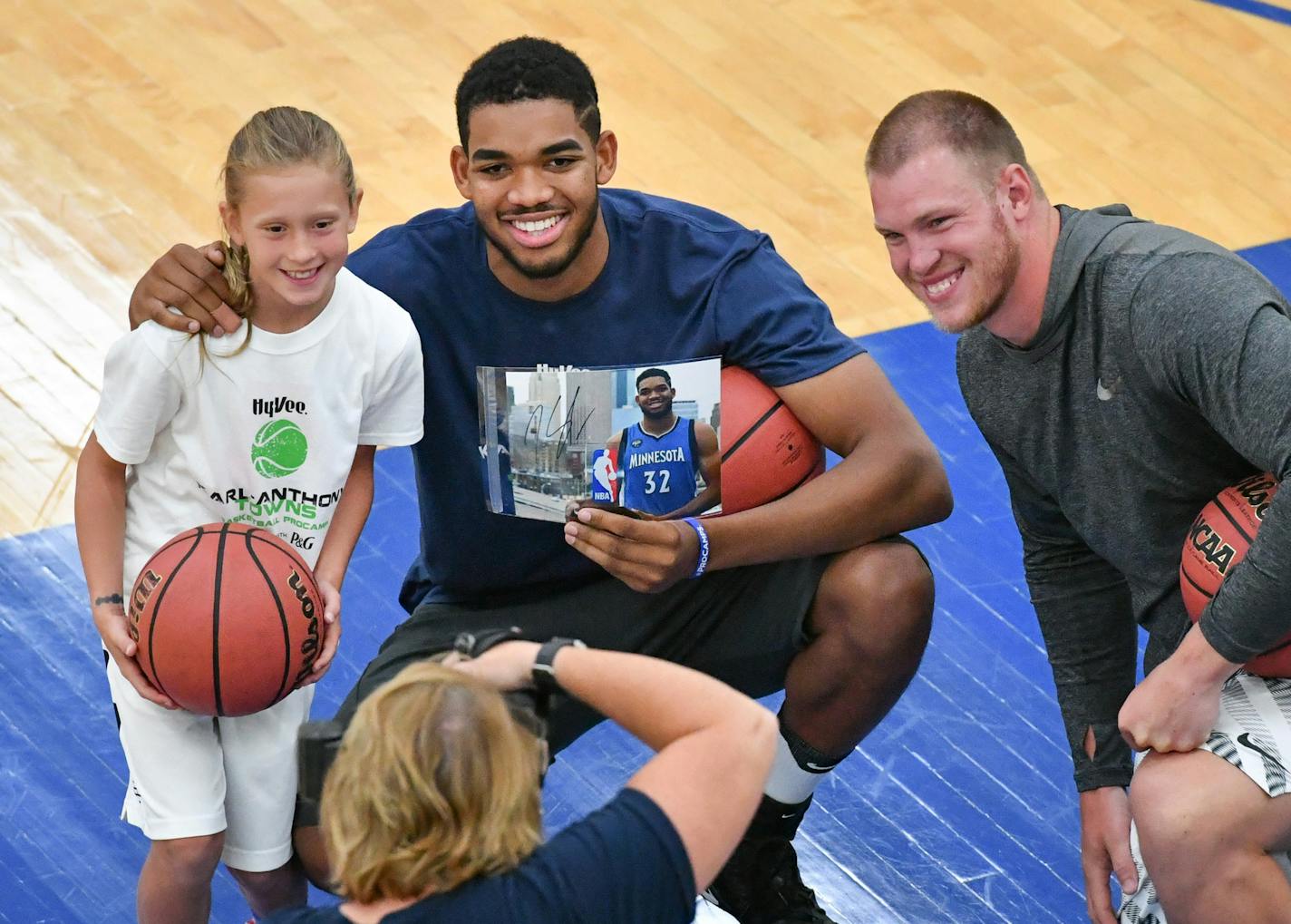 Karl-Anthony Towns posed for a photo with participant Maddye Greenway and Vikings tight end Kyle Rudolph after Maddye won a basket shooting contest at summer basketball camp at Hopkins High School. ] GLEN STUBBE * gstubbe@startribune.com Wednesday, July 27, 2016 The HyVee Karl-Anthony Towns summer basketball procamp at Hopkins High School. EDS, Maddyn is the daughter of Chad Greenway.