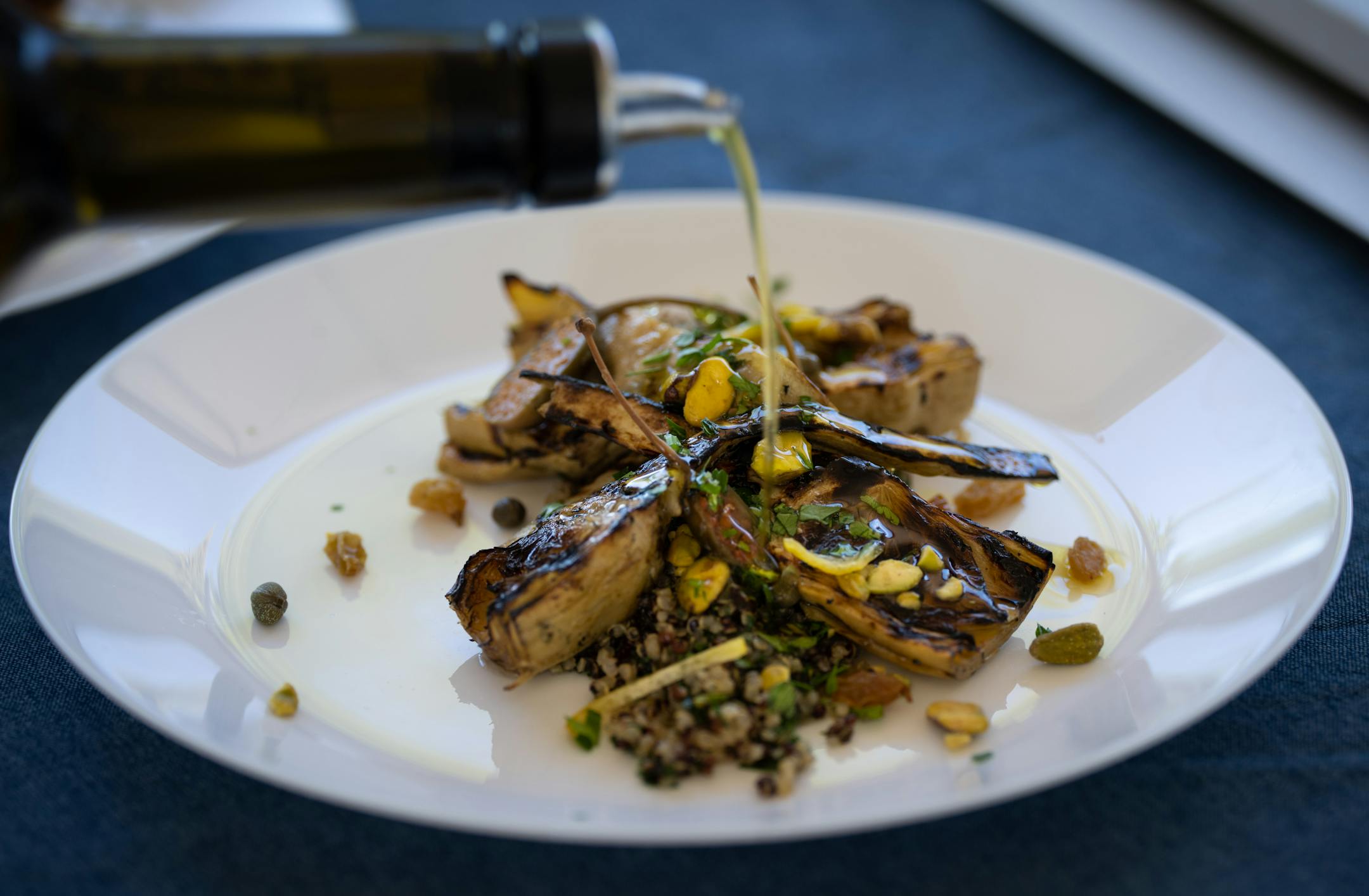 Sicilian artichokes drizzled with honey, capers, golden raisins, pistachio and parsley tabouleh at Gia at the Lake.