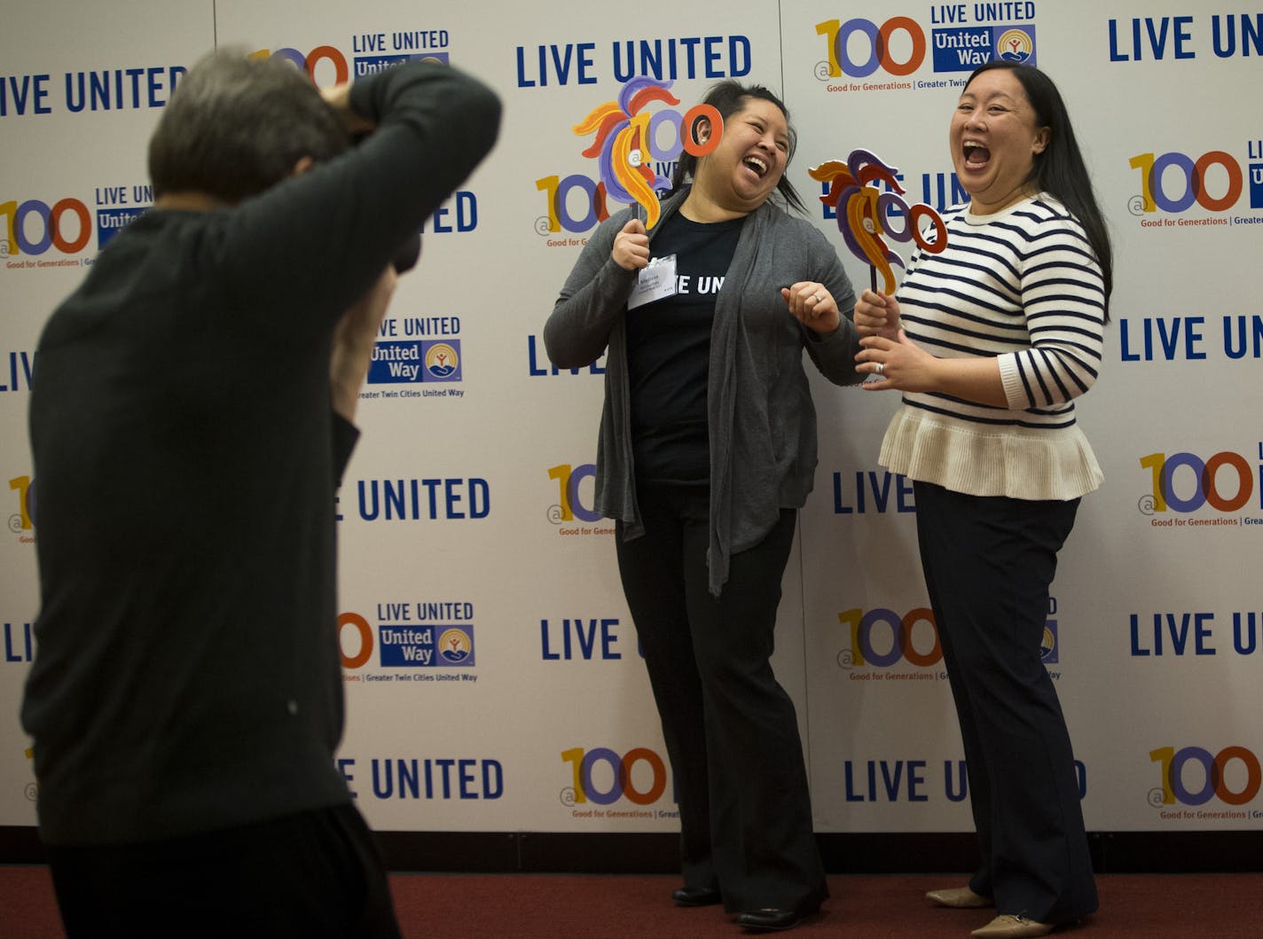 Photographer Bill Anstett took red carpet photographs of sisters Melissa Siri-outhay (with United Way 211) and Ouraphone Willis (with UnitedHealth Group) wearing "100" glasses at the United Way centennial celebration at the Minneapolis Convention Center in Minneapolis, Minn., on Thursday, February 19, 2015. ] RENEE JONES SCHNEIDER &#x2022; reneejones@startribune.com