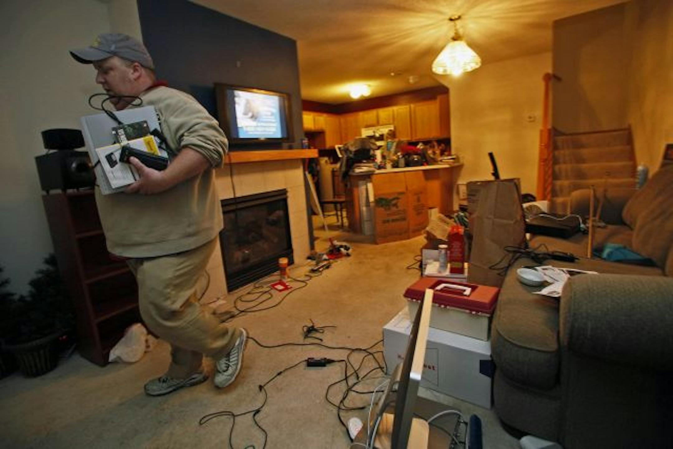 Greg Staffa packed his belongings before turning over the keys to the Farmington townhouse Saturday. He knows of two other foreclosed houses on the street. "This isn't an isolated, feel-sorry-for-Greg kind of thing," he says. "This affects a lot of people."