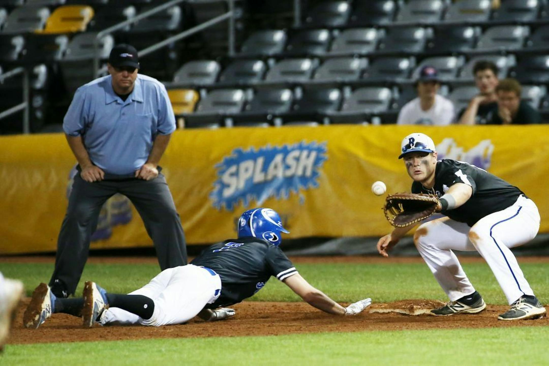 Hopkins infielder Luis Felemovicius slides safely back to first just before Easton Miller of Rogers catches the ball in the fifth inning of Friday's quarterfinals.