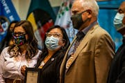 Melanie Benjamin, chief executive of the Mille Lacs Band of Ojibwe, stands with Gov. Tim Walz and Lt. Gov. Peggy Flanagan, who signed a bill affirming