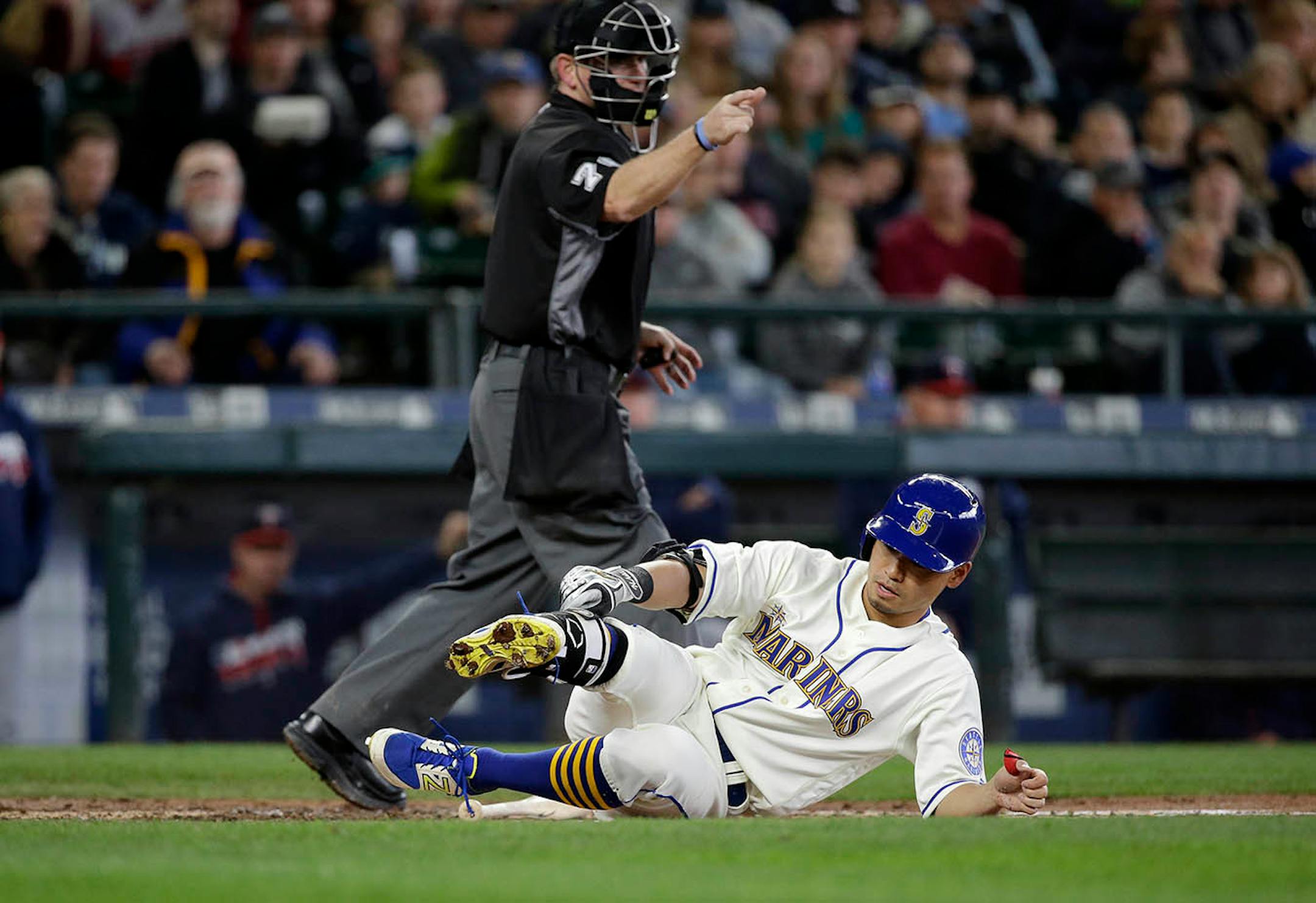 Umpire Mike Muchlinski signals Seattle Mariners' Norichika Aoki to take first after Aoki was hit by a pitch against the Minnesota Twins in a baseball game Sunday, May 29, 2016, in Seattle.