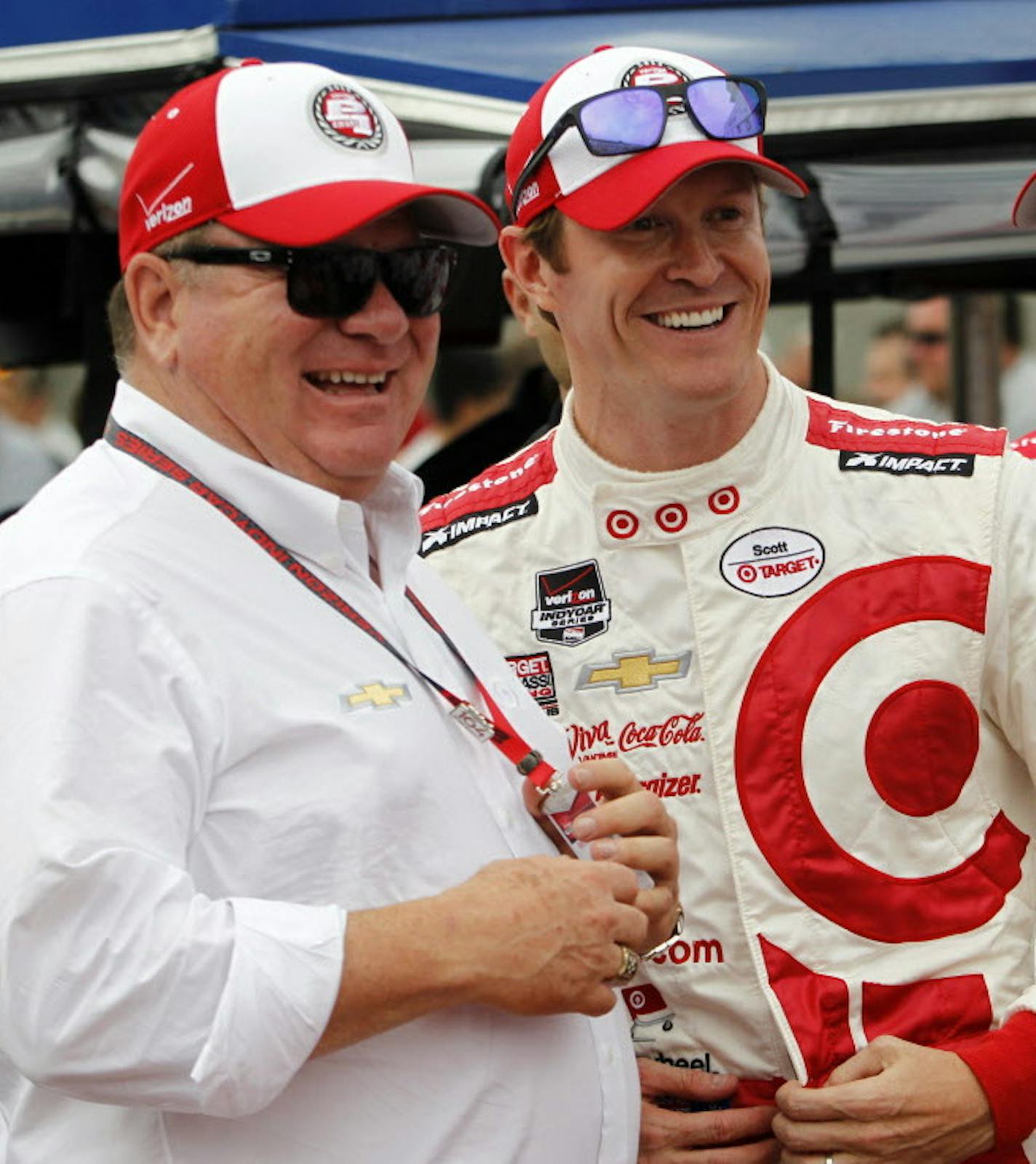 Scott Dixon, center, of New Zealand, laughs with car owner Chip Ganassi, left, after qualifying on the pole for the Indianapolis 500 auto race at Indianapolis Motor Speedway in Indianapolis, Sunday, May 17, 2015. (AP Photo/AJ Mast)