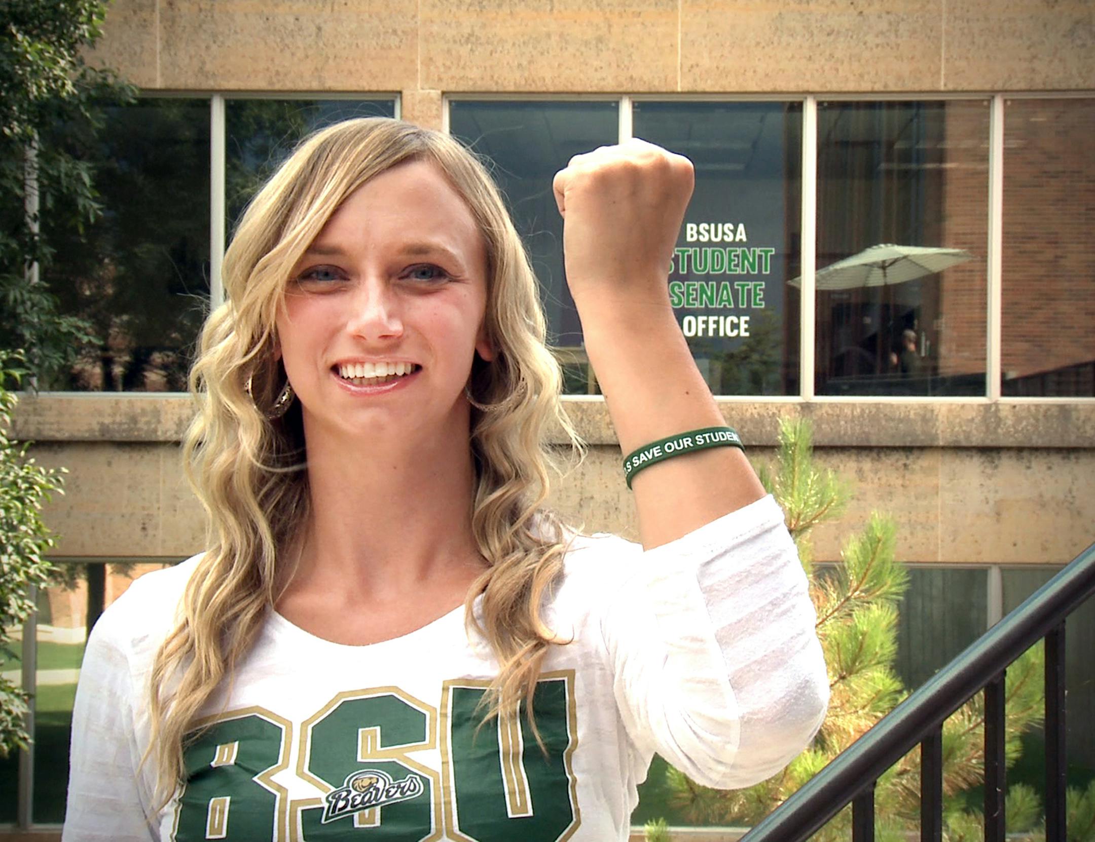 Student Senate President Brittany Hull shows off her Save Our Students wristband. A task force came up with the idea for wristbands and a video to promote safety after one student died and another was injured in the cold last school year.