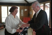 Eighth District U.S. Court of Appeals Judge Gerald Heaney at home in 1995 with his wife, Eleanor. They were folding a flag that was made for Heaney's 