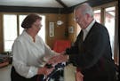 Eighth District U.S. Court of Appeals Judge Gerald Heaney at home in 1995 with his wife, Eleanor. They were folding a flag that was made for Heaney's 
