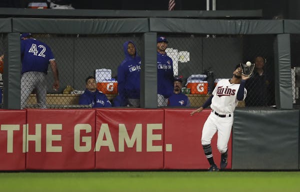 Twins center fielder Byron Buxton caught a hit to deep center by the Blue Jays' Freddy Galvis for a ninth inning out.