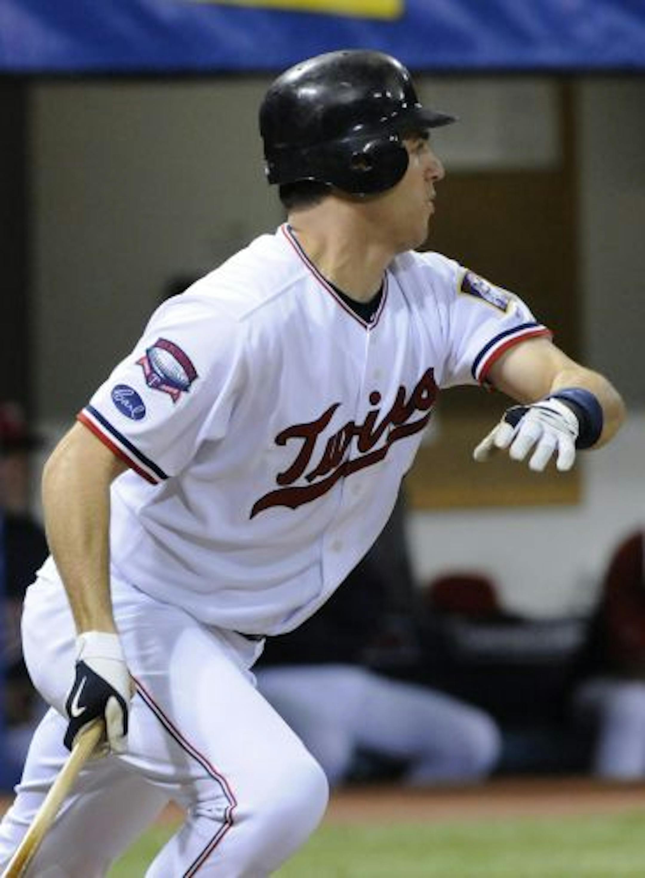 Minnesota Twins' Joe Mauer drives in a run against the Milwaukee Brewers in the third inning of a baseball game Saturday, May 23, 2009, in Minneapolis.