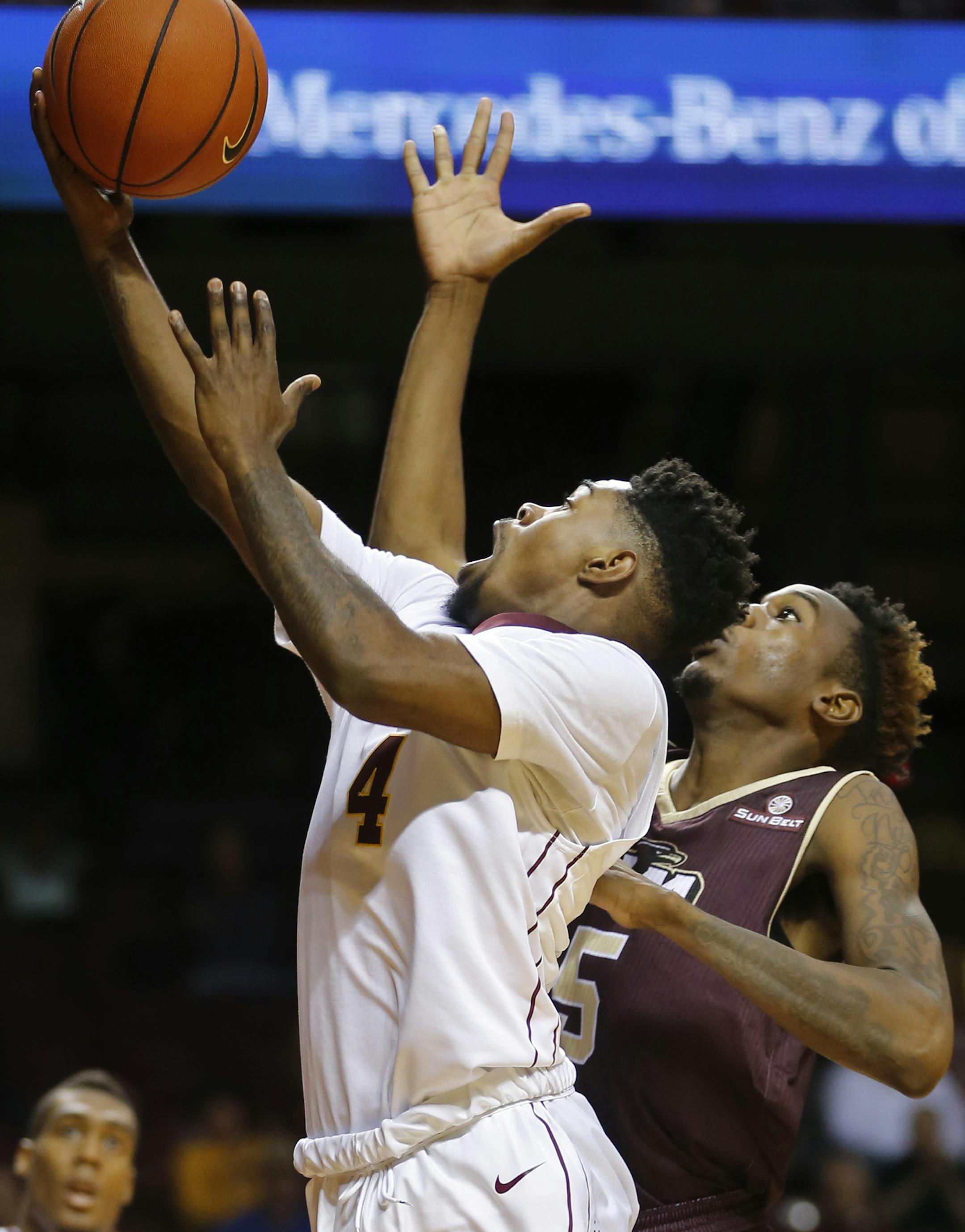 At Williams Aren in a game between University of Louisiana-Monroe and the U of M Gophers, Kevin Dorsey Jr.(4) went up for a layup as.Jammal Samuel(5) defended. The final score was 67-56 with the Gophers winning.]Richard Tsong-Taatarii/rtsong-taatarii@startribune.com