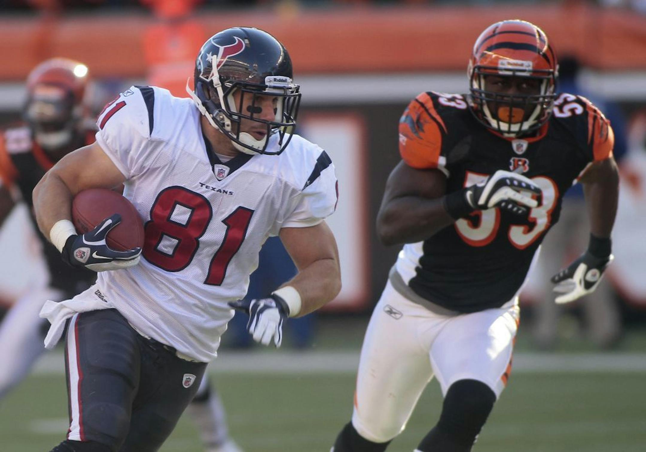 Houston Texans tight end Owen Daniels (81) runs past Cincinnati Bengals linebacker Thomas Howard (53) in the first half of an NFL football game, Sunday, Dec. 11, 2011, in Cincinnati.