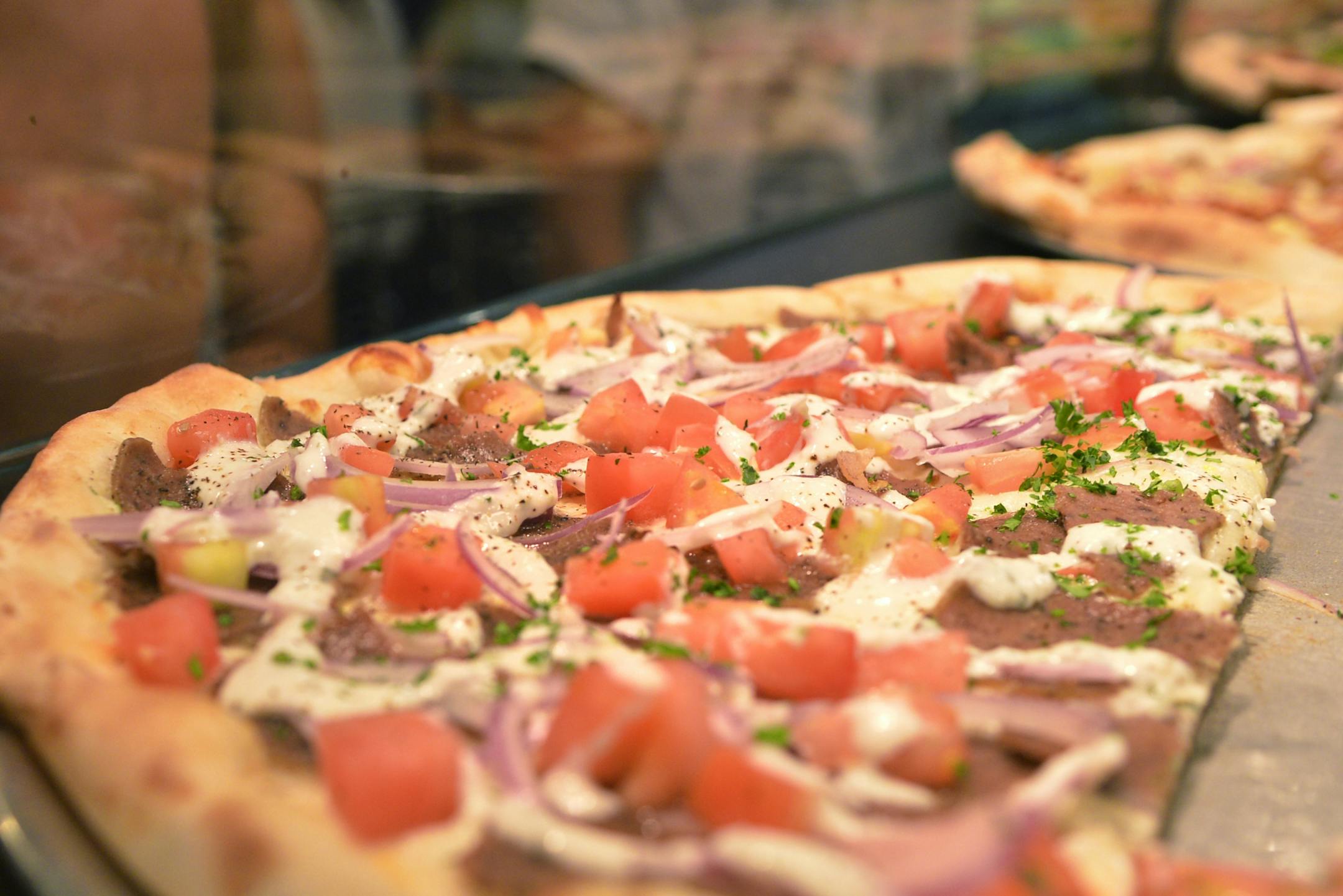 Gyro pizza-- Gyro meat, onions, tomatoes and cucumber sauce.